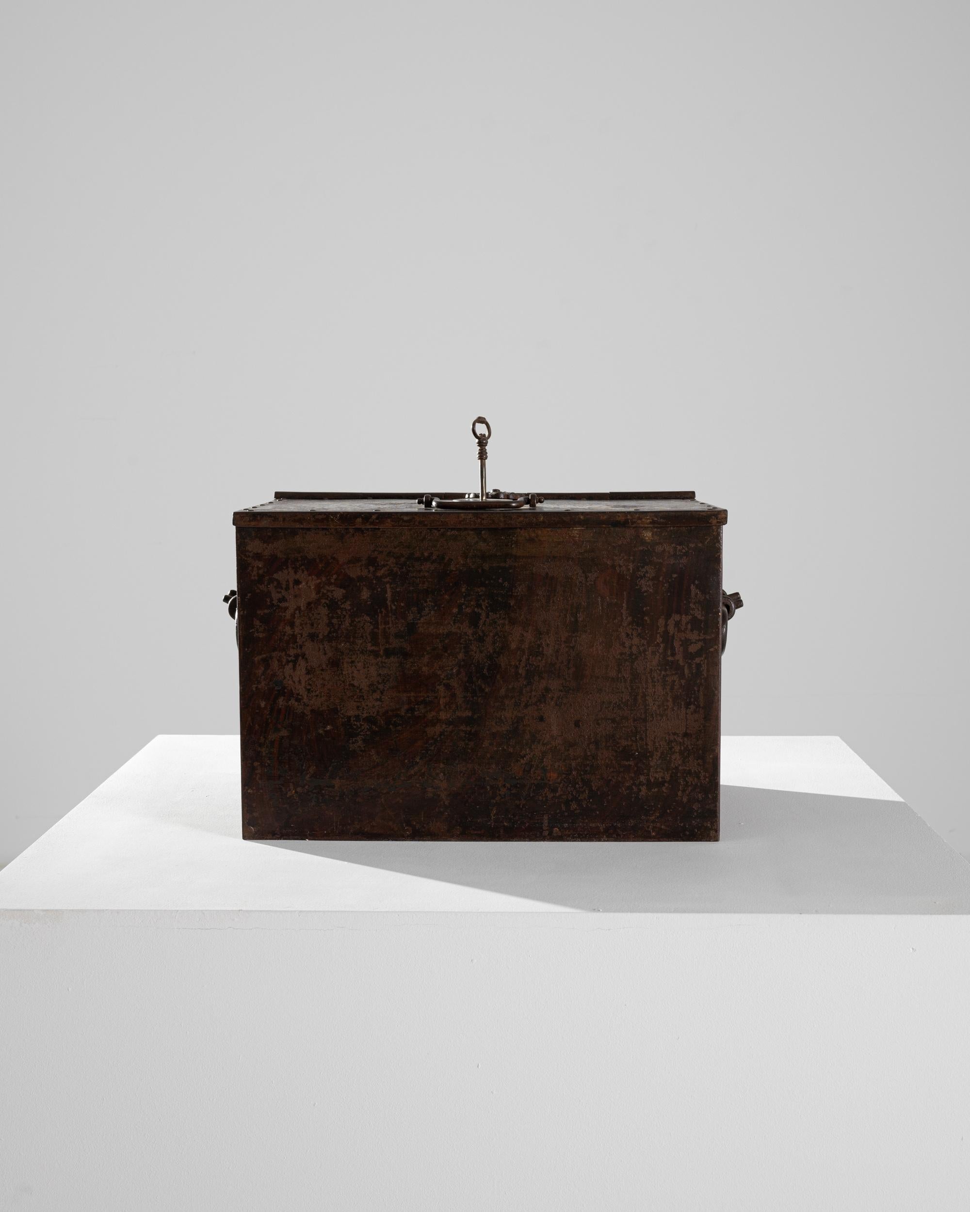 Originally used as a safe or strong-box, this antique iron trunk remains a trustworthy vault for treasured possessions. Made in 19th century France, the surface of the metal has aged to a dark, velvety patina, giving the trunk an air of mystery. An