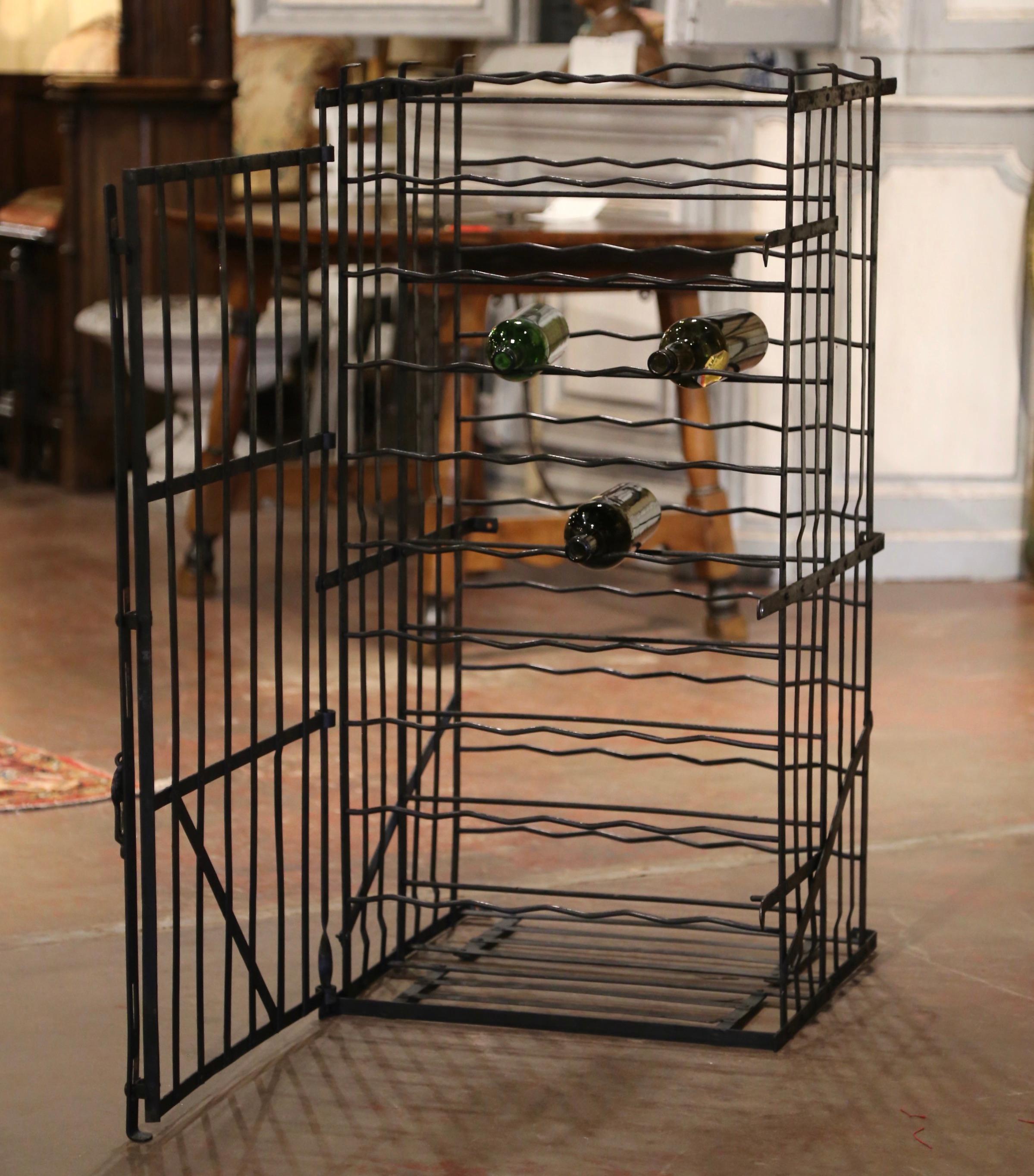 Decorate a wine cellar with this exquisite antique wine storage cabinet with wall mounted brackets. Forged in the Burgundy region of France and rectangular in shape, the open cage built with iron strap construction, features a large hinged door with