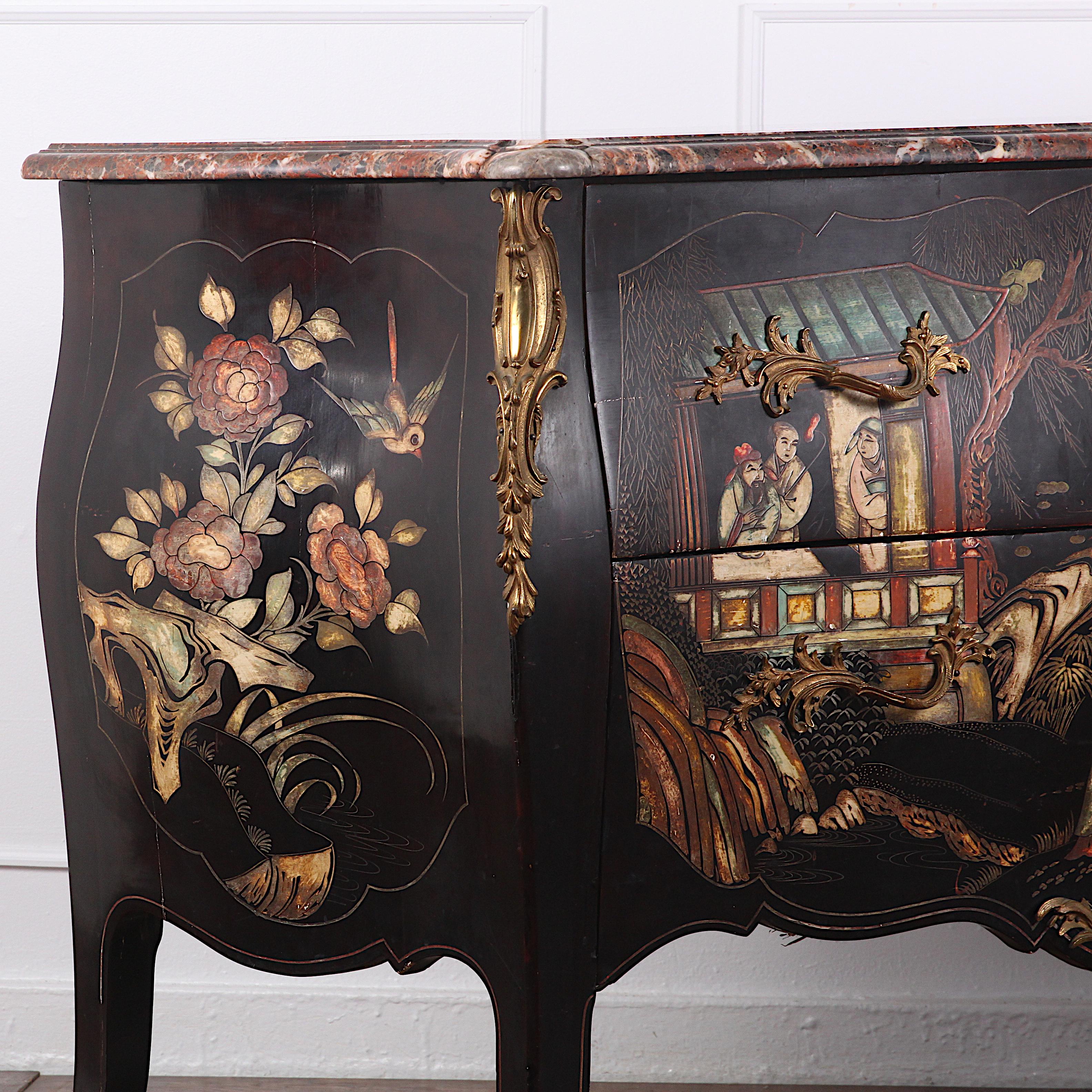 A highly-decorative and rare French ‘bombe’ commode with dramatic black lacquer Japanned or ‘Chinoiserie’ finish featuring figures in various landscape and pavilion settings, and floral details to the sides. Original complex shaped marble top; fine