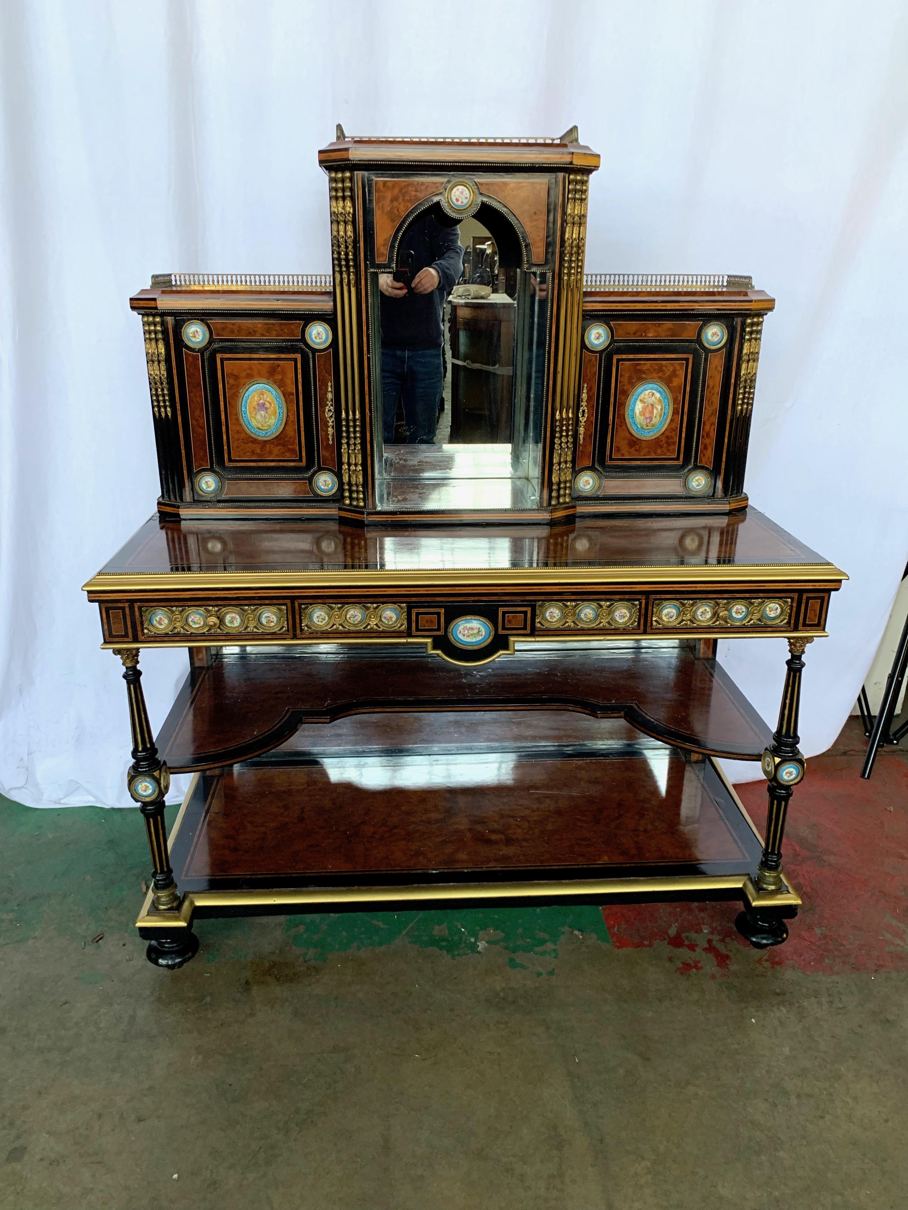 A fine 19th century French Kingwood and porcelain mirrored cabinet on stand. The upper portion fitted with a central mirrored recess flanked by a pair of cupboards. All above a single frieze drawer and mirrored base. Ormolu mounts throughout.