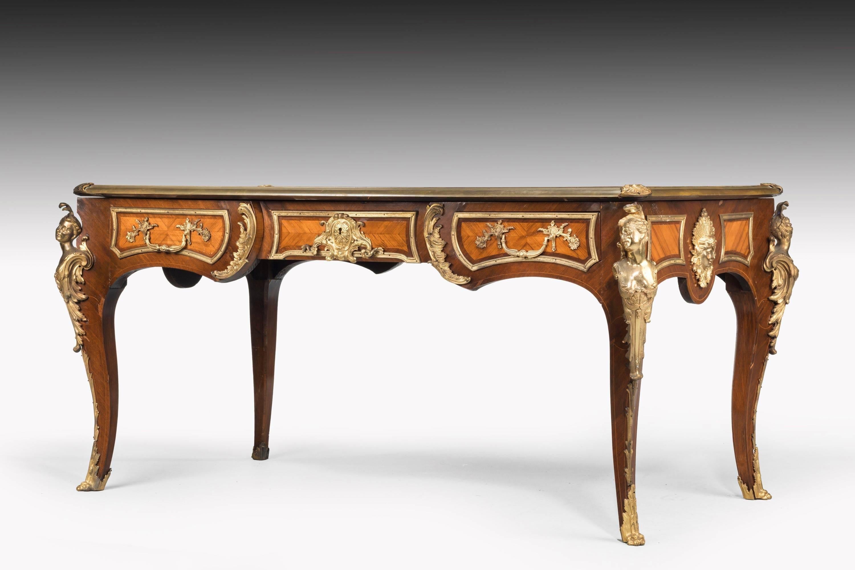 A 19th century French kingwood and rosewood writing table. Particularly fine and original gilt bronze mounts and sabots. Pronounced strong construction, large in relationship to the proportions of the table and entirely original.