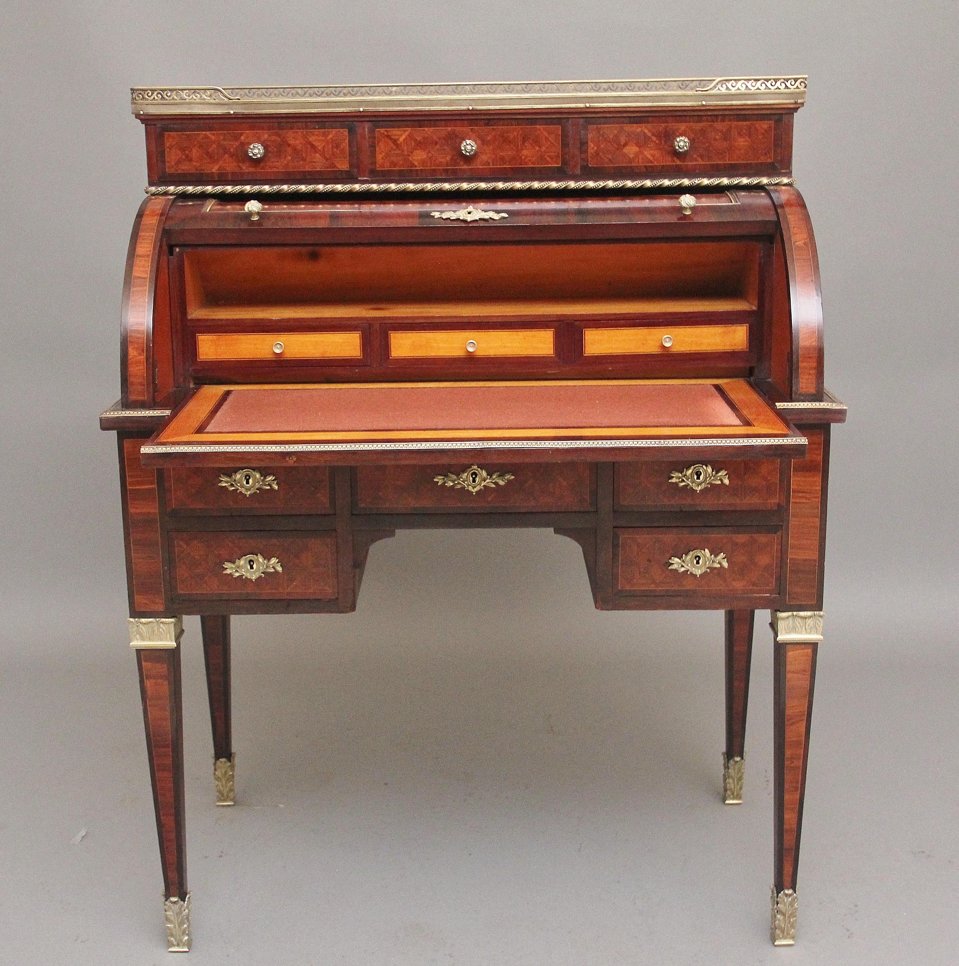 19th Century French Kingwood cylinder desk of exceptional quality, the top structure having a pierced brass gallery with a veined marble top and three drawers below with decorative ormolu moulding running along the bottom, the cylinder lifting up to