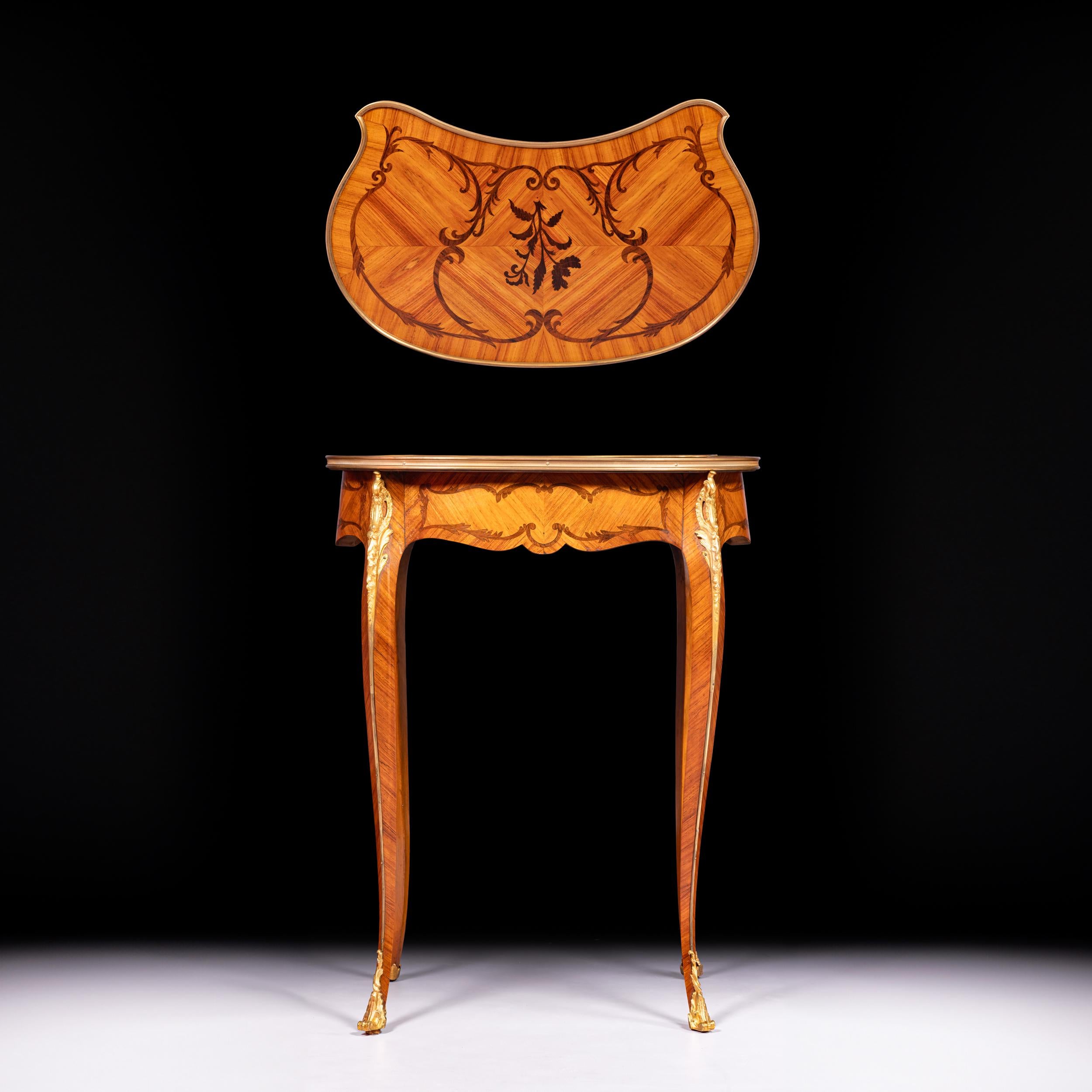 A very fine and elegant kidney shaped side / occasional table, raised by four delicately scrolled cabriole legs the kidney-shaped table is fitted with a small central drawer. The table top is decorated with a pattern marquetry, while the sides also