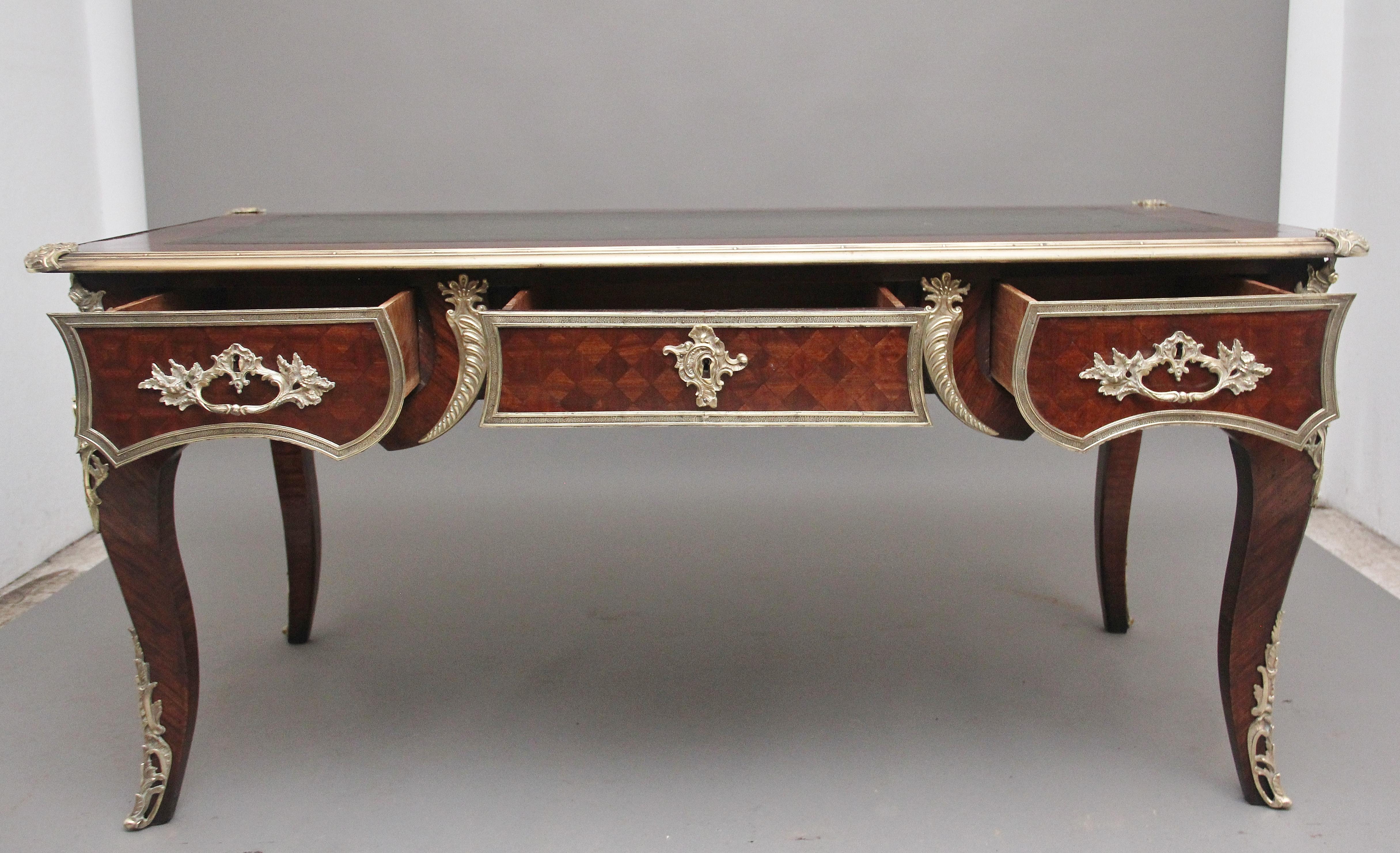 A superb quality large 19th century French Kingwood and ormolu mounted bureau-plat desk, having a rectangular shaped top with an ormolu moulded edge, decorative shell engraved corner mounts, kingwood cross banding around the edge and a green leather