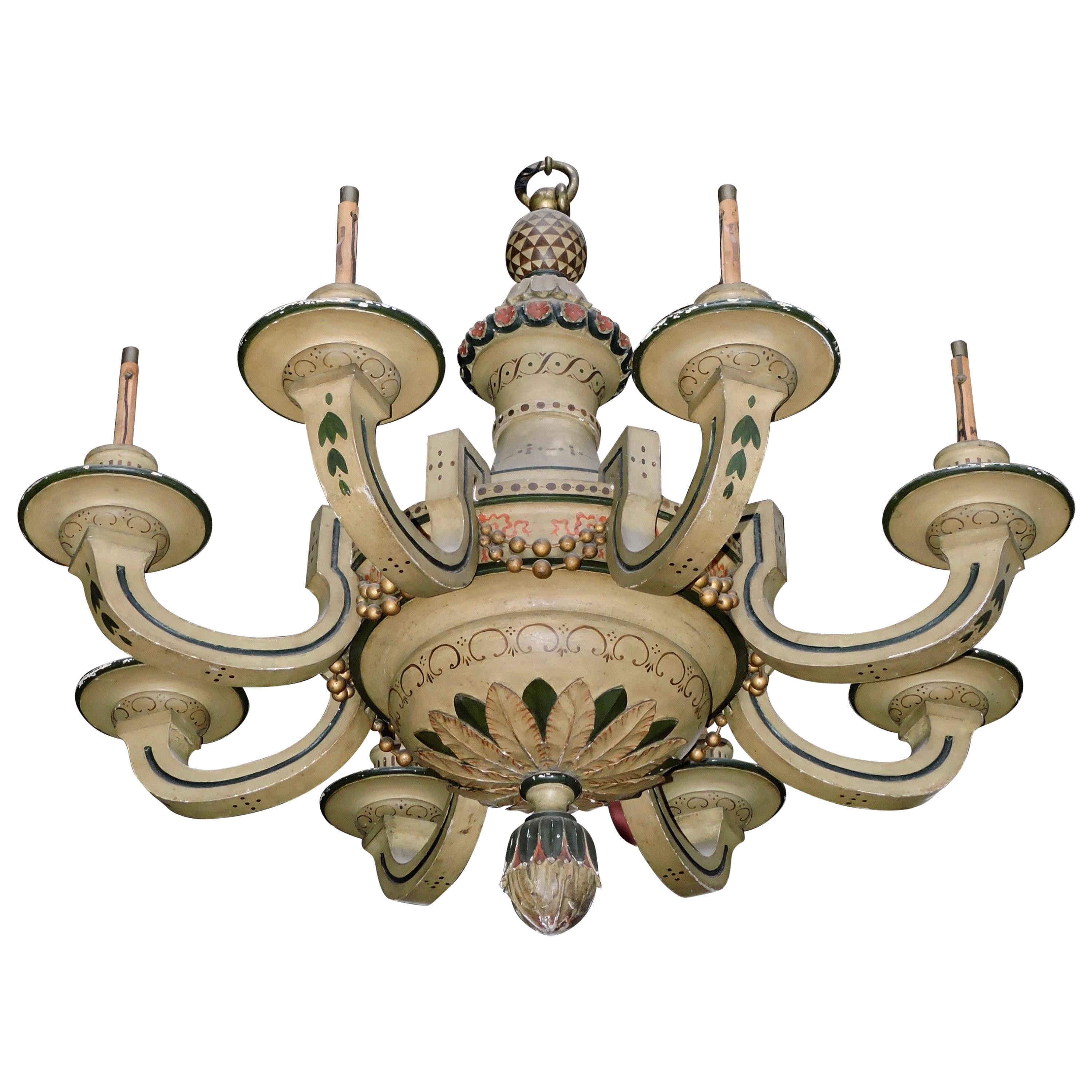 A 19th century French polychromed lacquered wood eight-light chandelier

Lacquered gloss cream wood with green, red and brown highlights
Contained vase ending in foliated seed welcoming eight arms forming semicircles.
The top has a frieze of red
