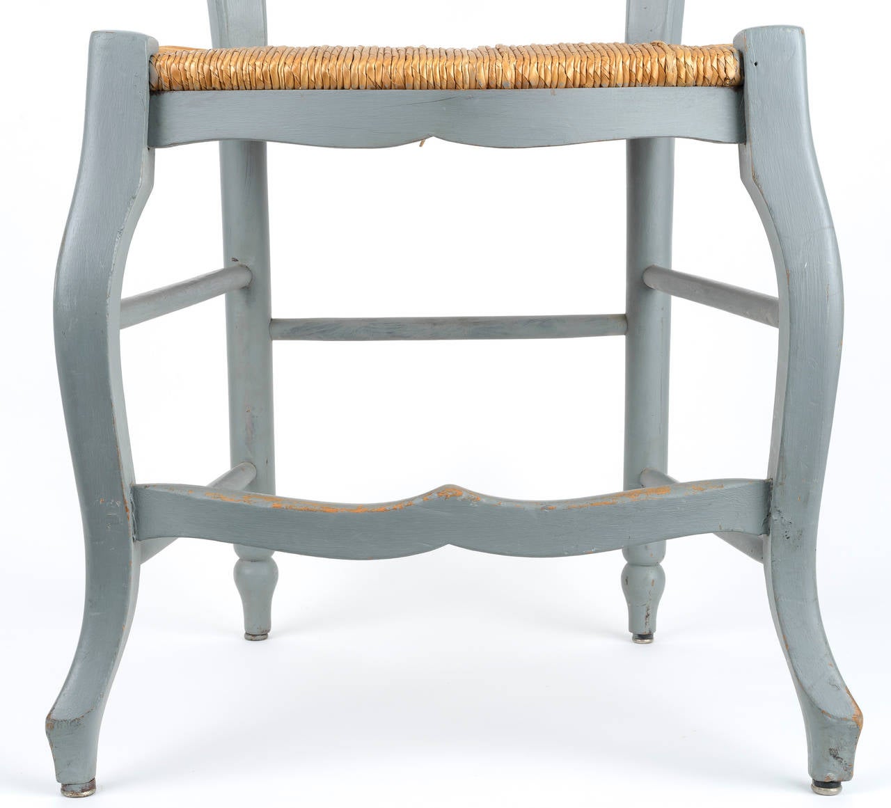 Charming pair painted of ladder back chairs with shaped vertical and horizontal rails. The top rail has a carved basket and floral motif. The chairs have cabriole legs and a scalloped apron and stretcher.
  