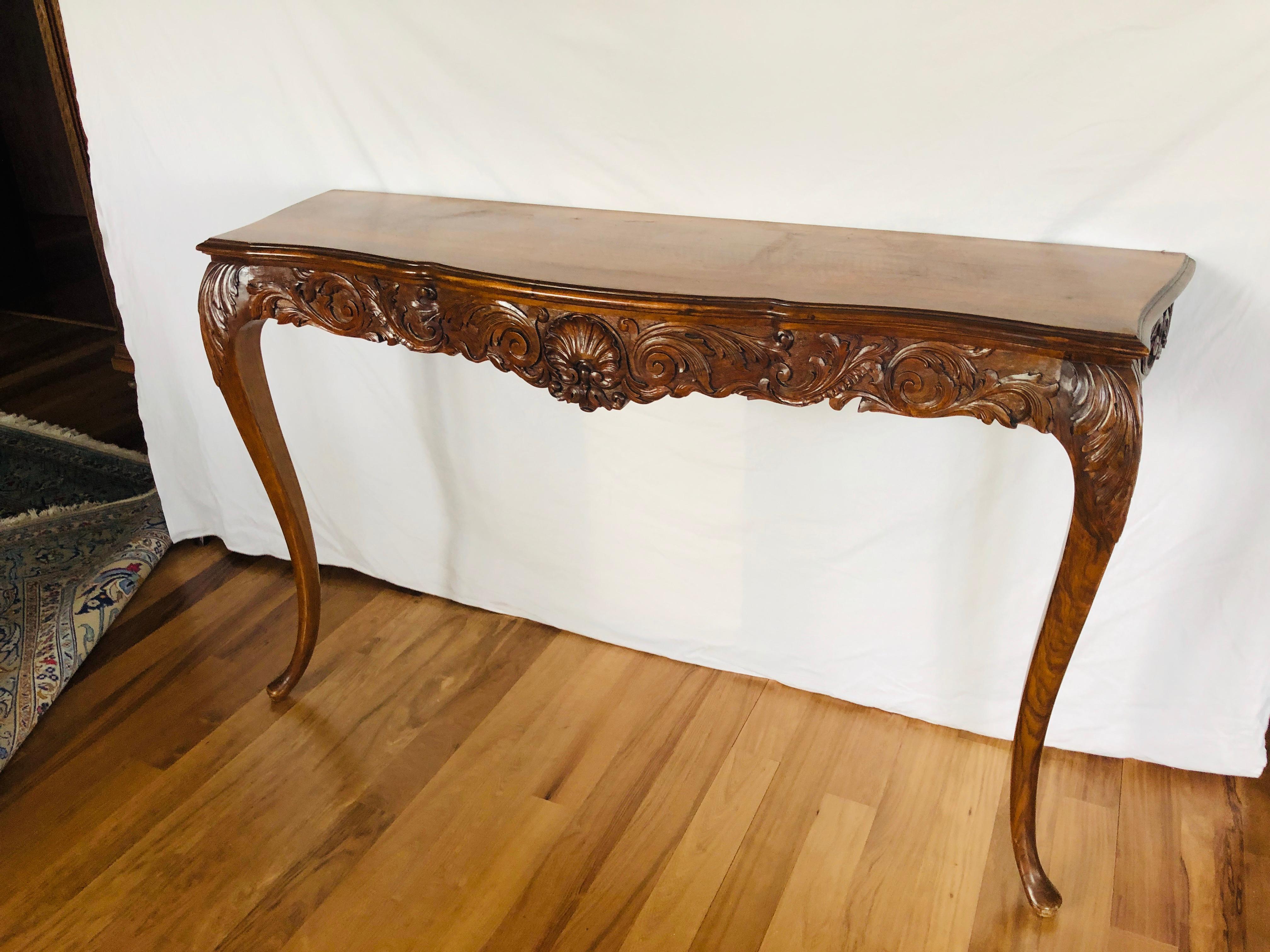 French large walnut console resting on arched legs having a beautifully hand carved front part and large wooden top. Very good condition and very stable structure.
France, circa 1890.
 