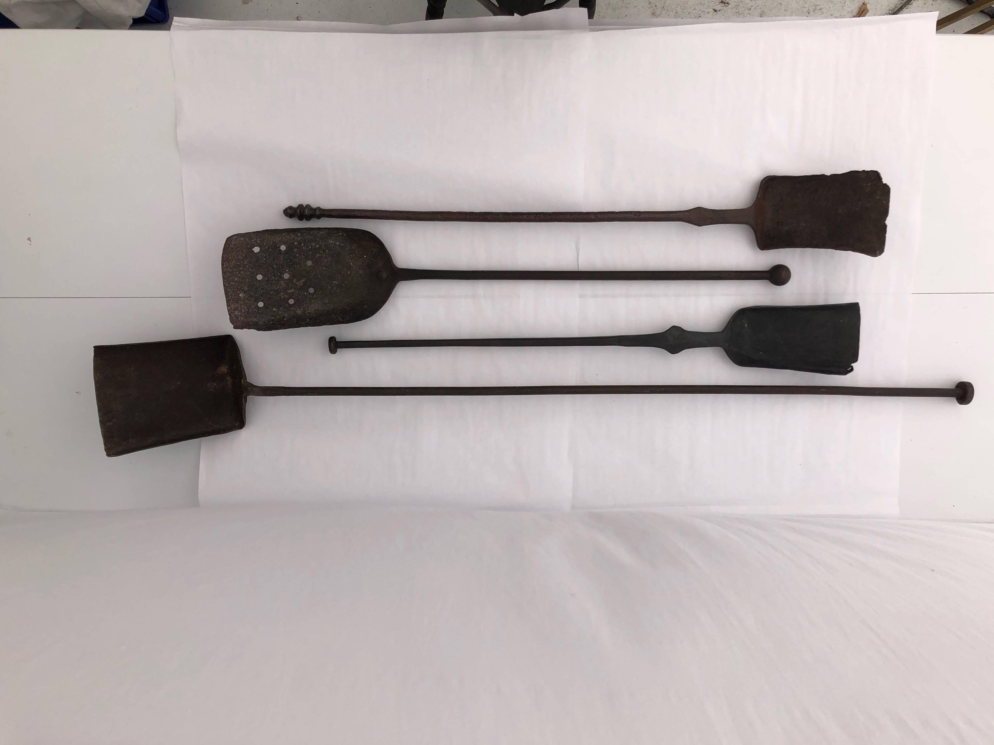 These are a wonderful set of four 19th century French large wrought iron fireplace ash shovels. They have four different hand-forged tops that are just great. These would add such character to any fireplace display and could still be used as