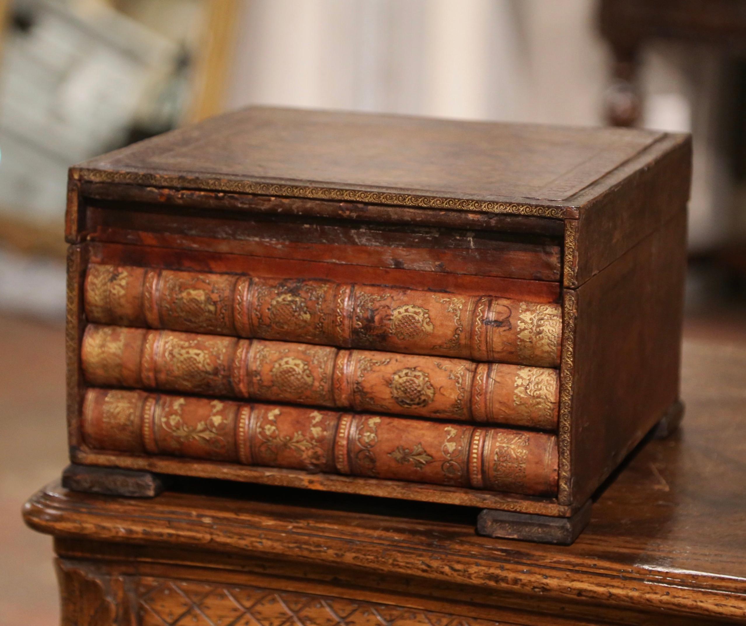 Store your TV remote controls or other valuables in this decorative leather box. Created in France circa 1880, the box is shaped as three antique leather bound books stacked together, with the lower book functioning as a hidden drawer. The box