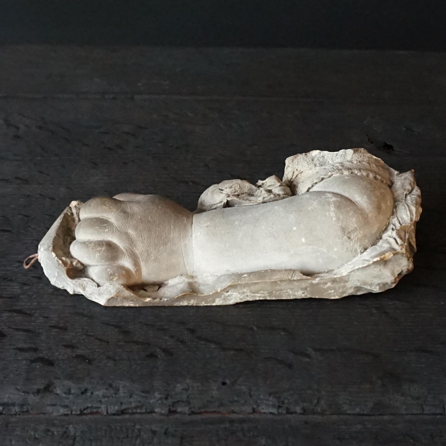 The cutest chubby little 19th century plaster life size and very lifelike study of a Baby's hand and arm with ruffled sleeve detail. You can see the pores on the skin and the softness of the skin of this (I think) a year old sleeping infant.
I've