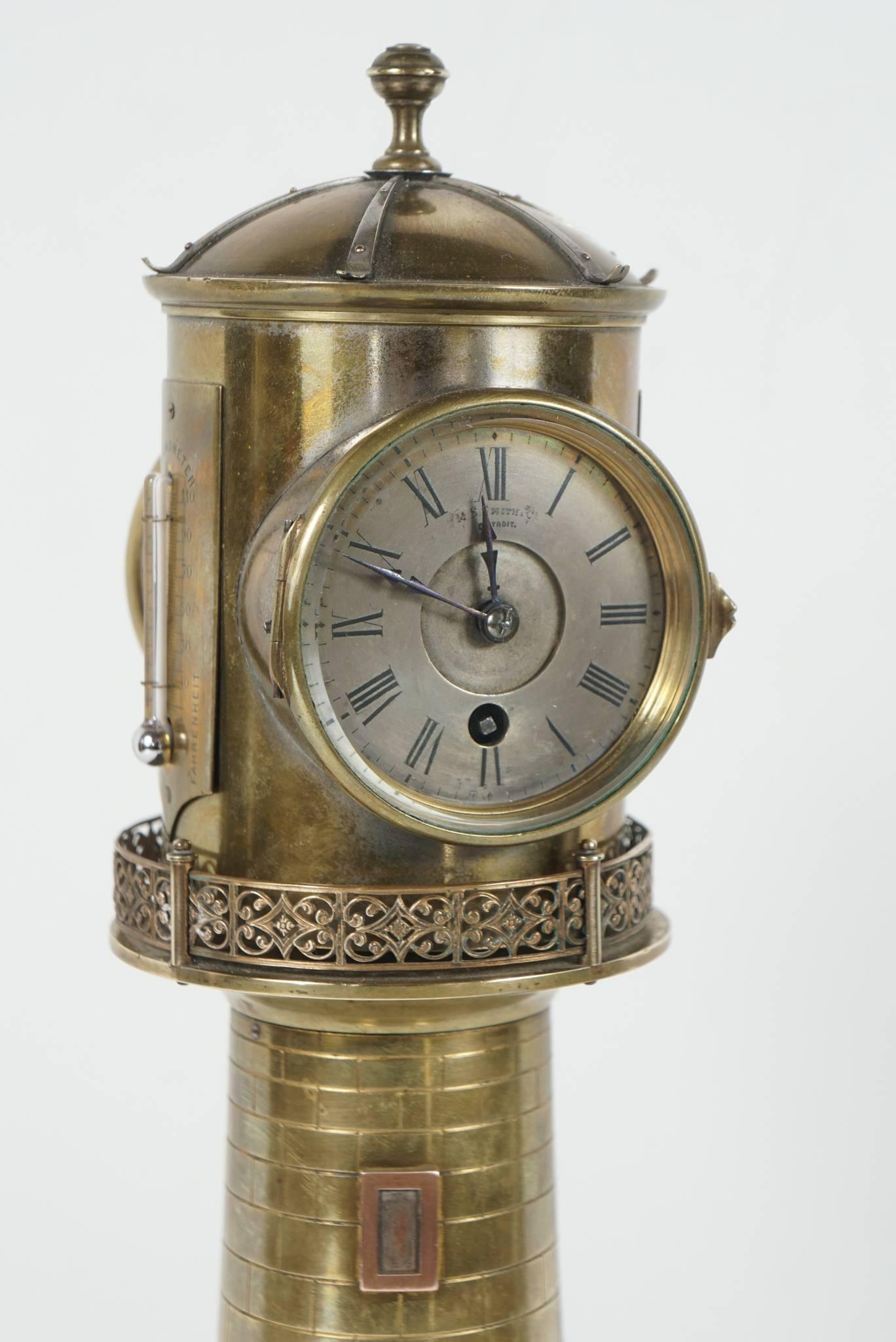 This lighthouse clock crafted by Andre Romain Guilmet in Paris, circa 1880 is made of bronze, copper and was silvered in areas. The clock works with an eight-day movement housed in the top or lighthouse section and is opposed by a barometer within