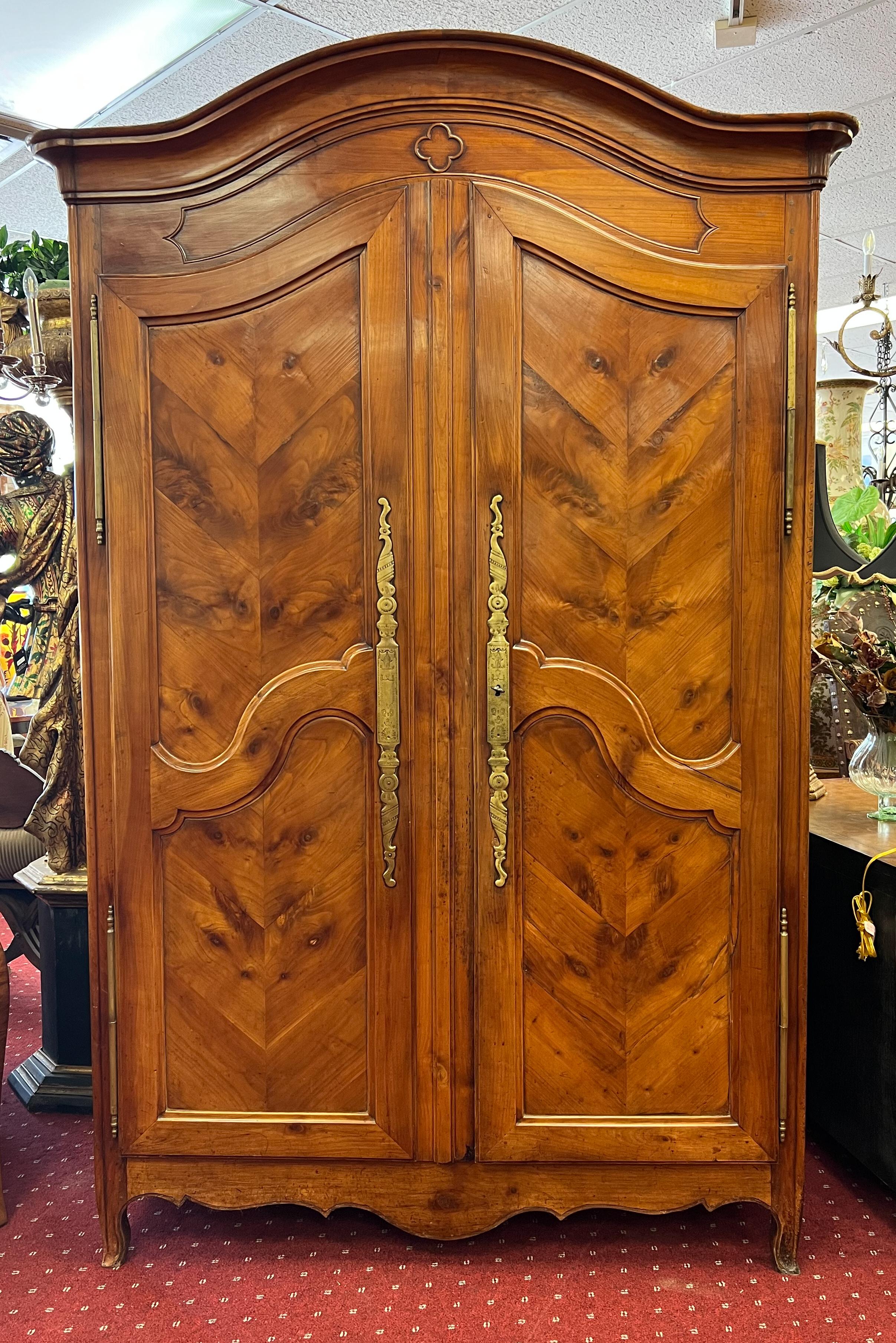 An incredible piece of handcrafted furniture. Circa early 19th Century, this French armoire is just over 8 feet tall. The interior features three built-in shelves, making for four levels of ample storage. It was once used as a linen armoire, but in