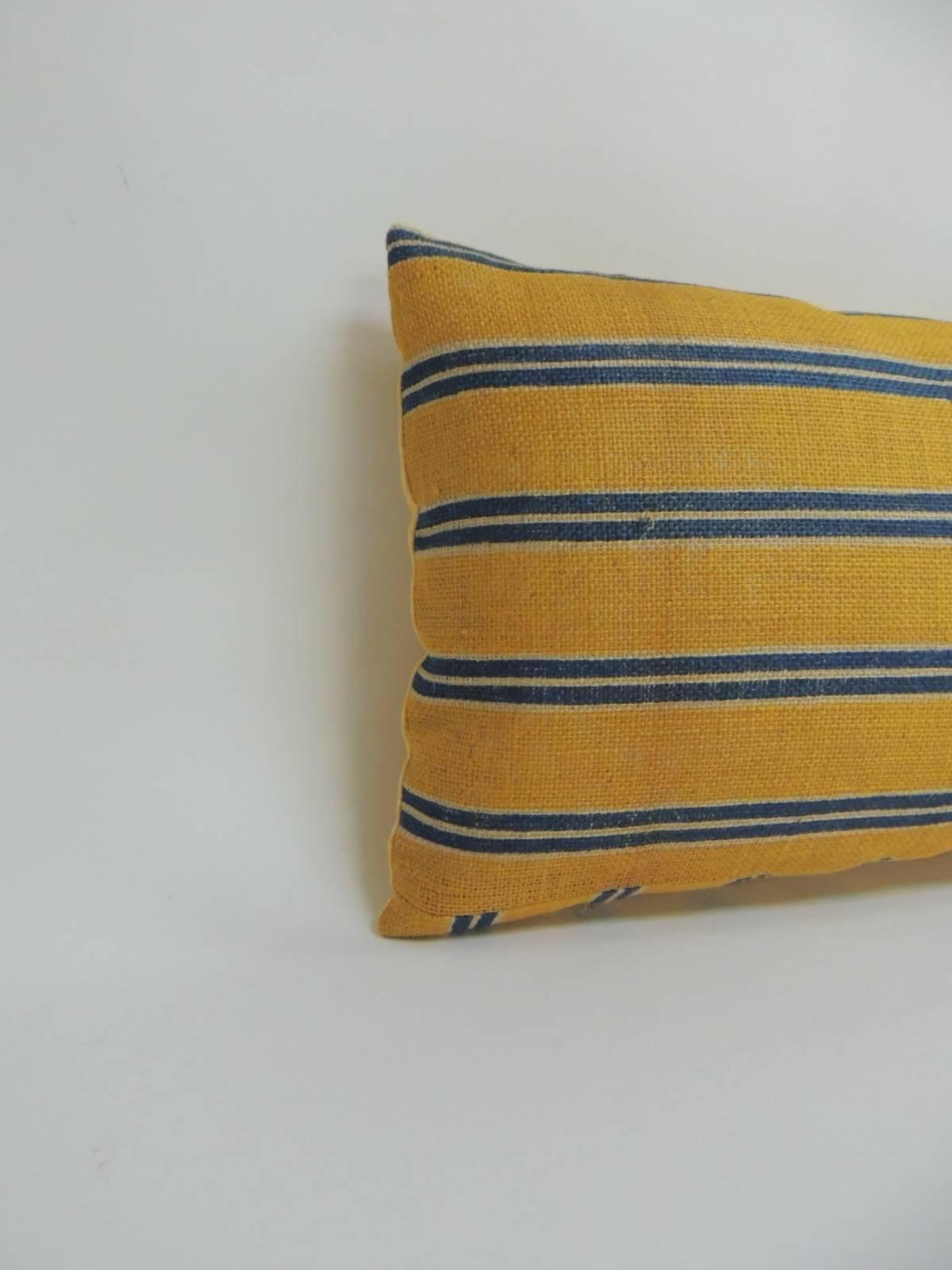 19th century French linen stripes in shades of blue and yellow on antique textile linen. Long bolster throw pillow finished with quilted yellow cotton backing.
Accent bolster pillow hand-crafted and designed in the USA. Throw bolster pillow with