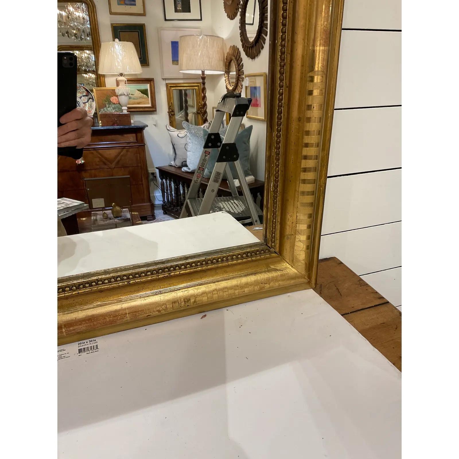 A magnificent 19th century French Louie Phillipe mirror. It features an elaborate hand carved design and a beaded inner border with no missing areas. Mirrors of this style, named for the French King Louie Phillipe who reigned from 1830 to 1848, are