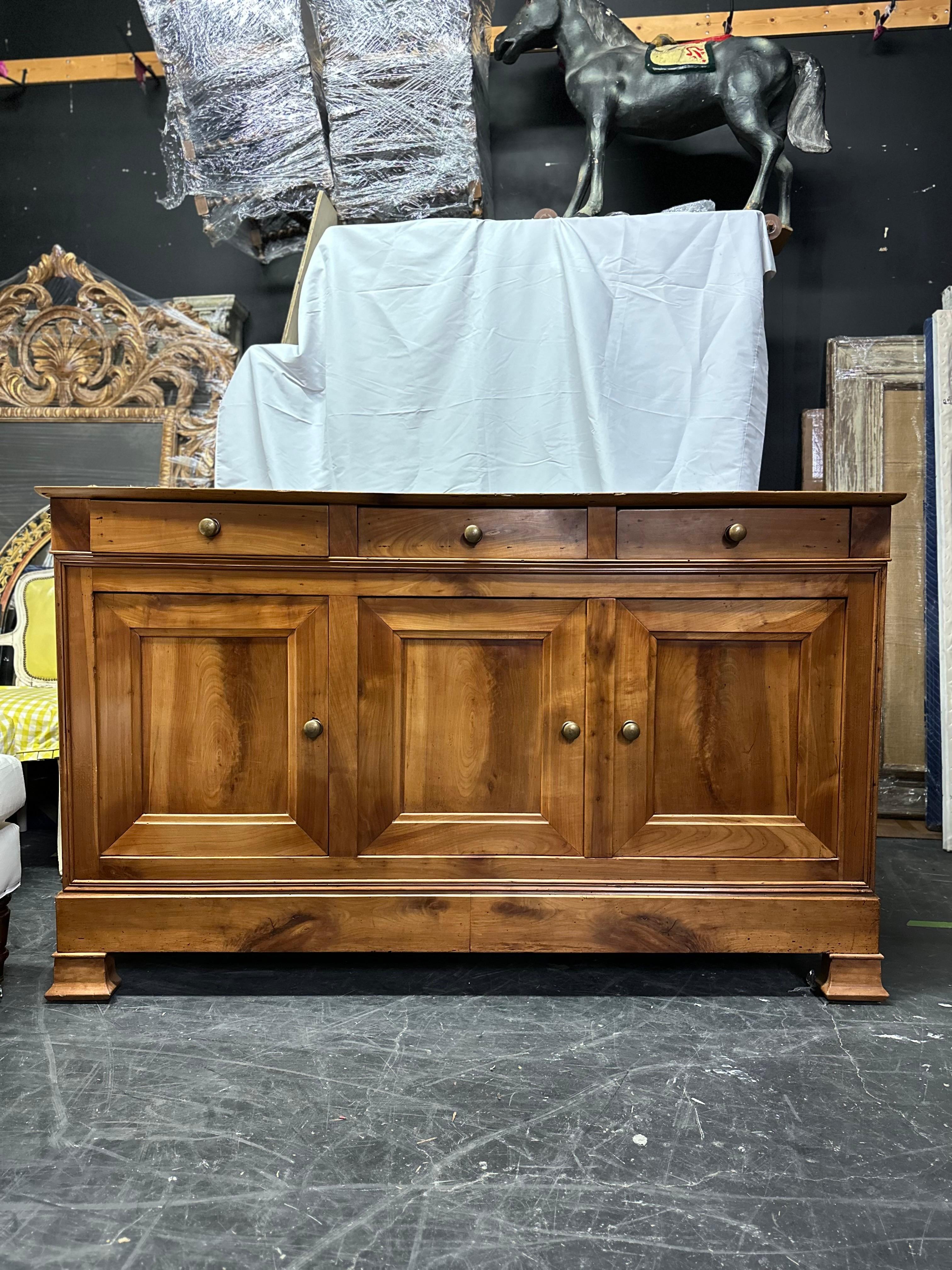 This 19th-century French Louis Philippe style enfilade is a testament to the timeless elegance of period furniture. Crafted from solid walnut around the 1890s, it boasts a sophisticated yet understated design that seamlessly marries form and