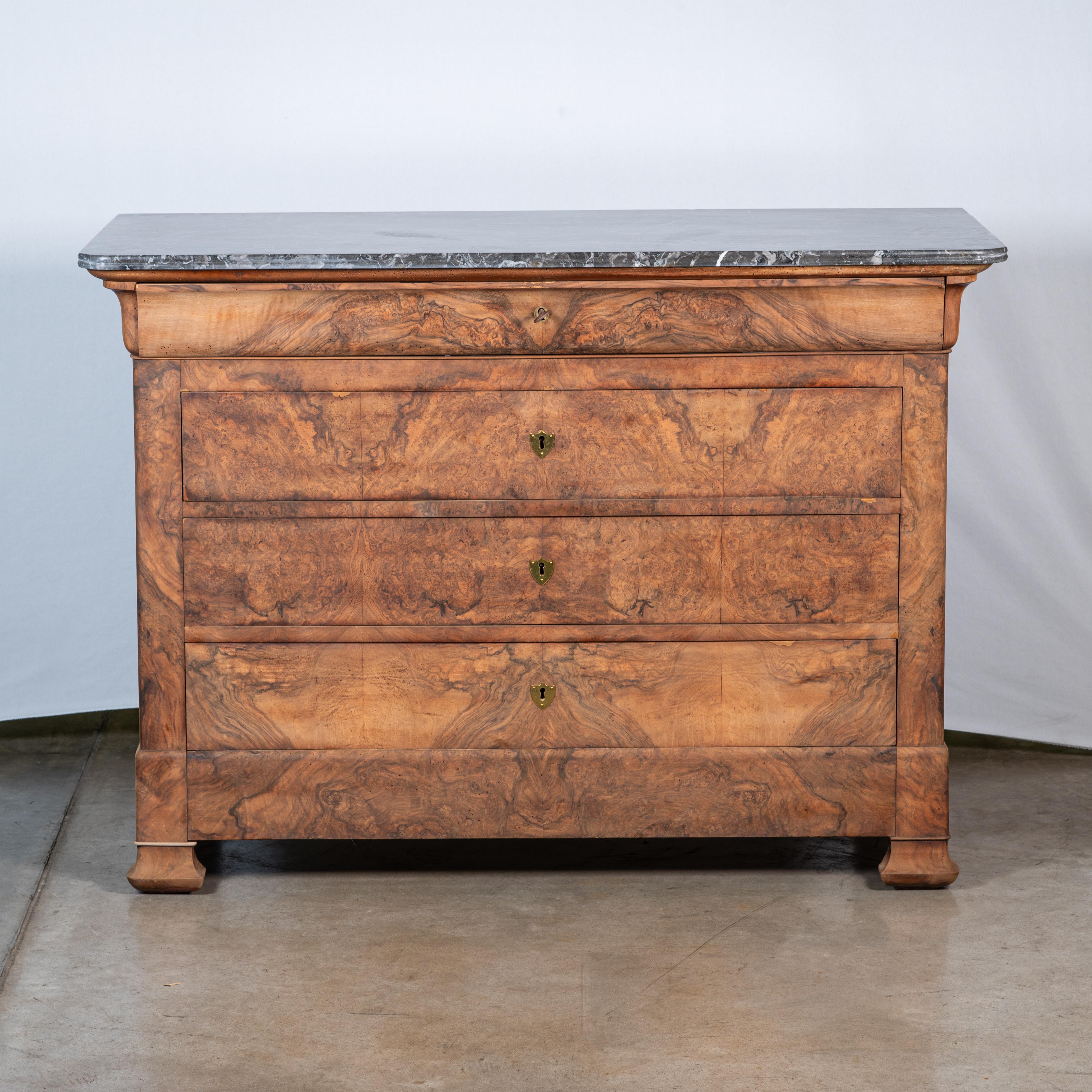 Introducing the exquisite 19th Century French Louis Philippe Burl Walnut Commode, a testament to the timeless elegance of French craftsmanship. Crafted with precision from luxurious burl walnut wood, this magnificent commode exudes sophistication