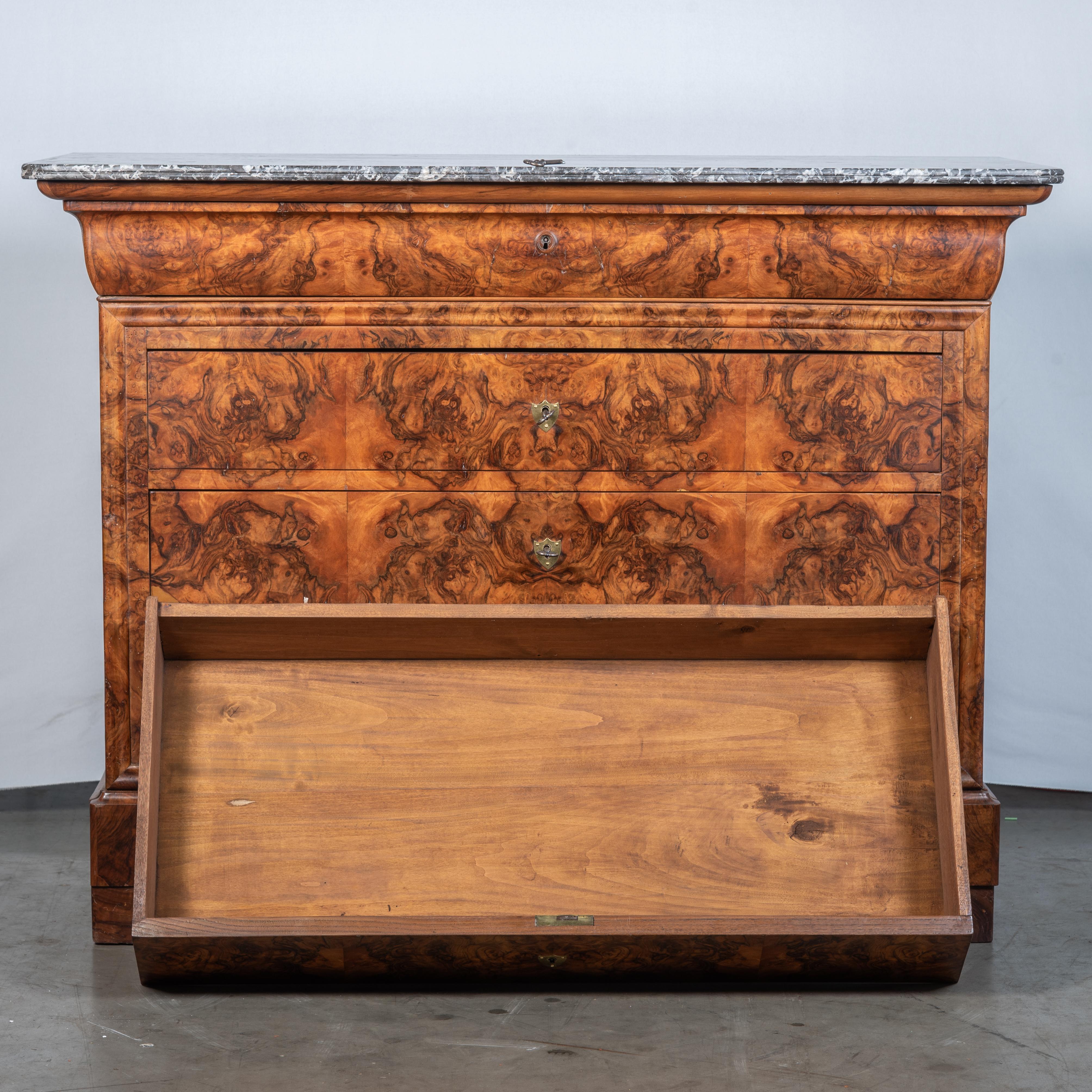 Immerse yourself in the exquisite craftsmanship and timeless elegance of the 19th Century French Louis Philippe Burl Walnut Commode, a stunning piece that pays homage to the distinctive style of King Louis Philippe.

King Louis Philippe, who reigned