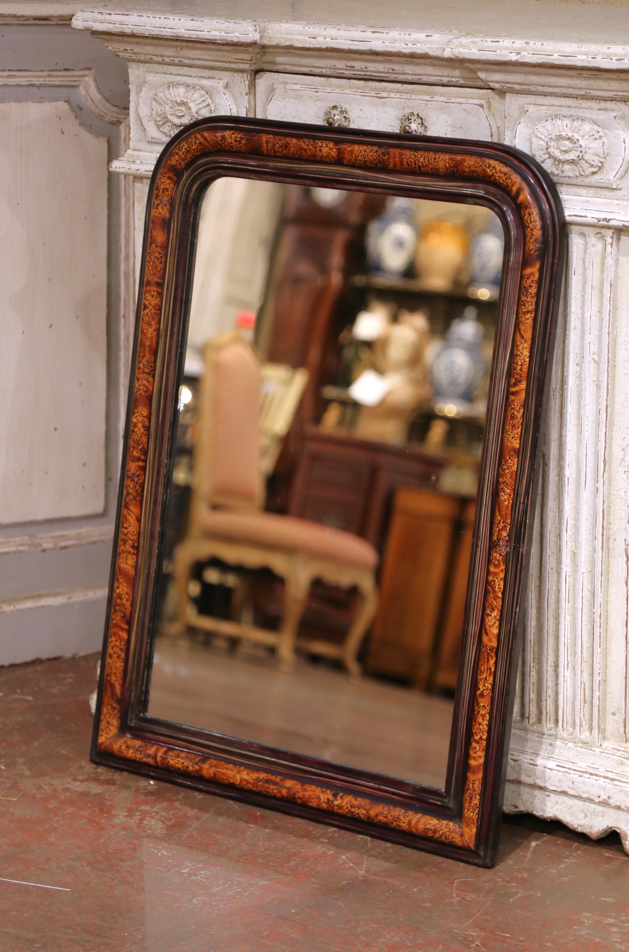 Bring warmth and depth to any interior with this richly figured Louis Philippe mirror. Crafted in France circa 1880, the frame features the classic rounded corners and clean silhouette of the Louis Philippe style, but is elevated by the use of burl