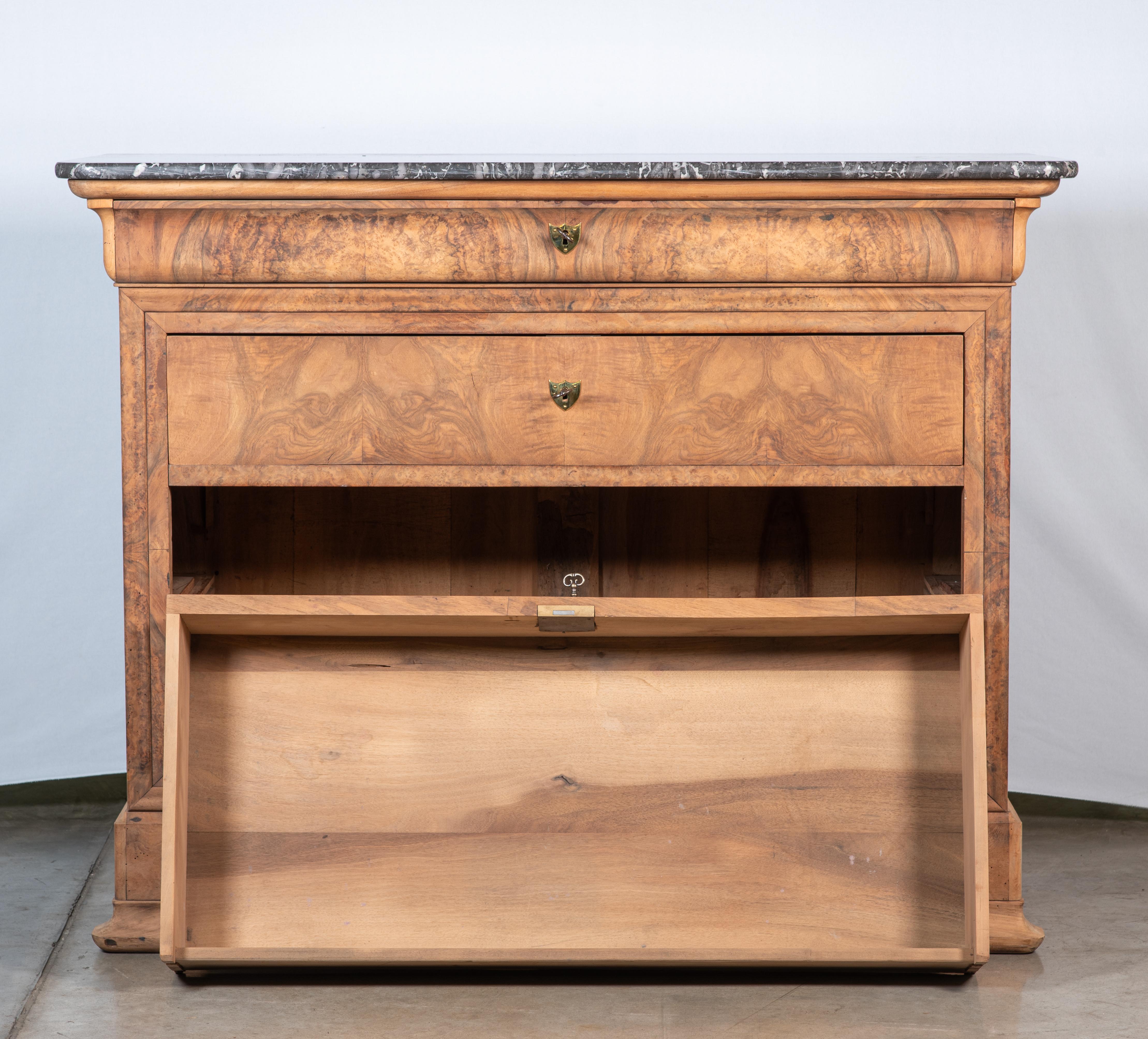 Immerse yourself in the timeless elegance of the Louis Philippe era with our exquisite 19th Century French Louis Philippe Burl Walnut Veneer Commode. Crafted to perfection, this stunning piece encapsulates the refined aesthetics and meticulous
