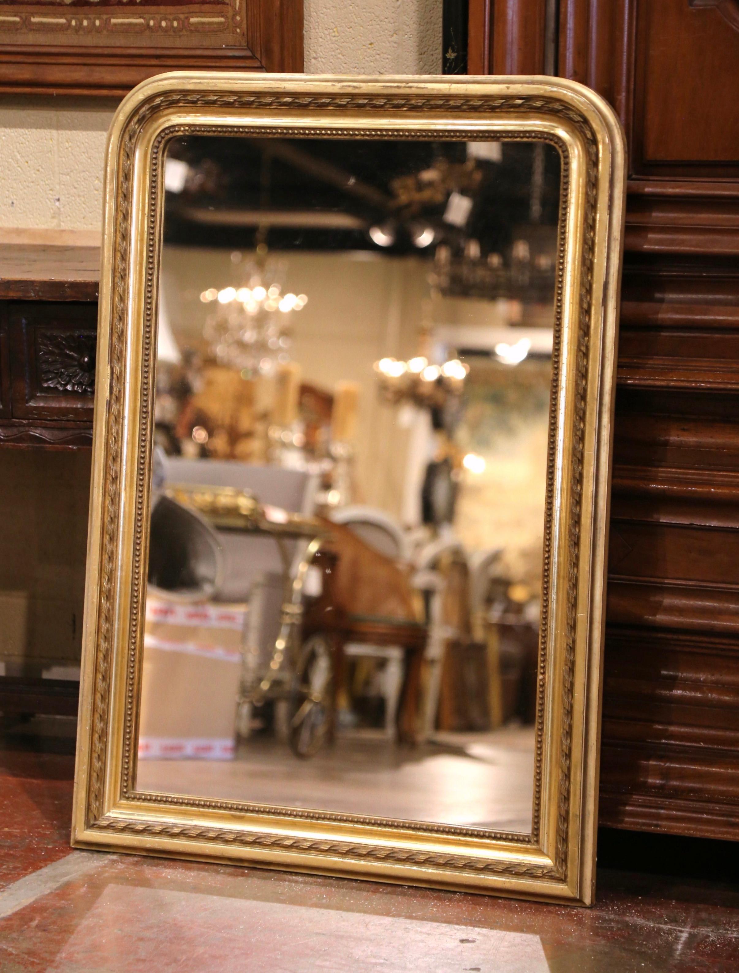 Decorate an entry or a powder room with this elegant antique wall mirror. Crafted in France circa 1860, the rectangular wall piece has rounded corners; the frame with beaded trim around the mirror, is decorated with a fine raised rope motif over the