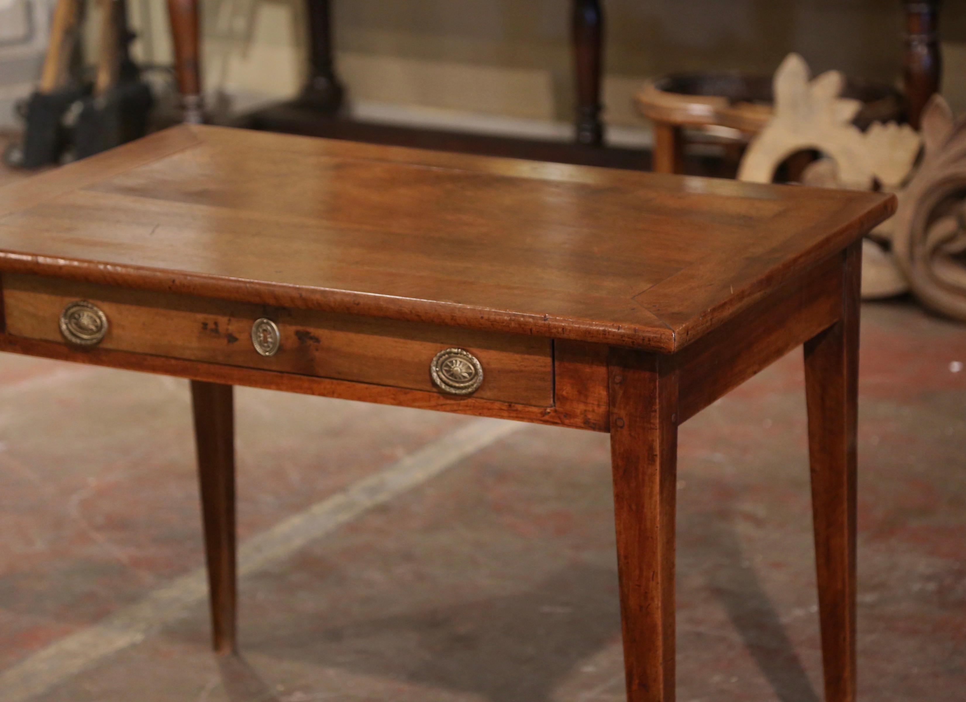 This versatile, antique fruitwood end table could easily be mixed into any room in your home. The simple, linear Louis Philippe style side table was carved in the Poitou region of France, circa 1830. The small writing table stands on tapered legs