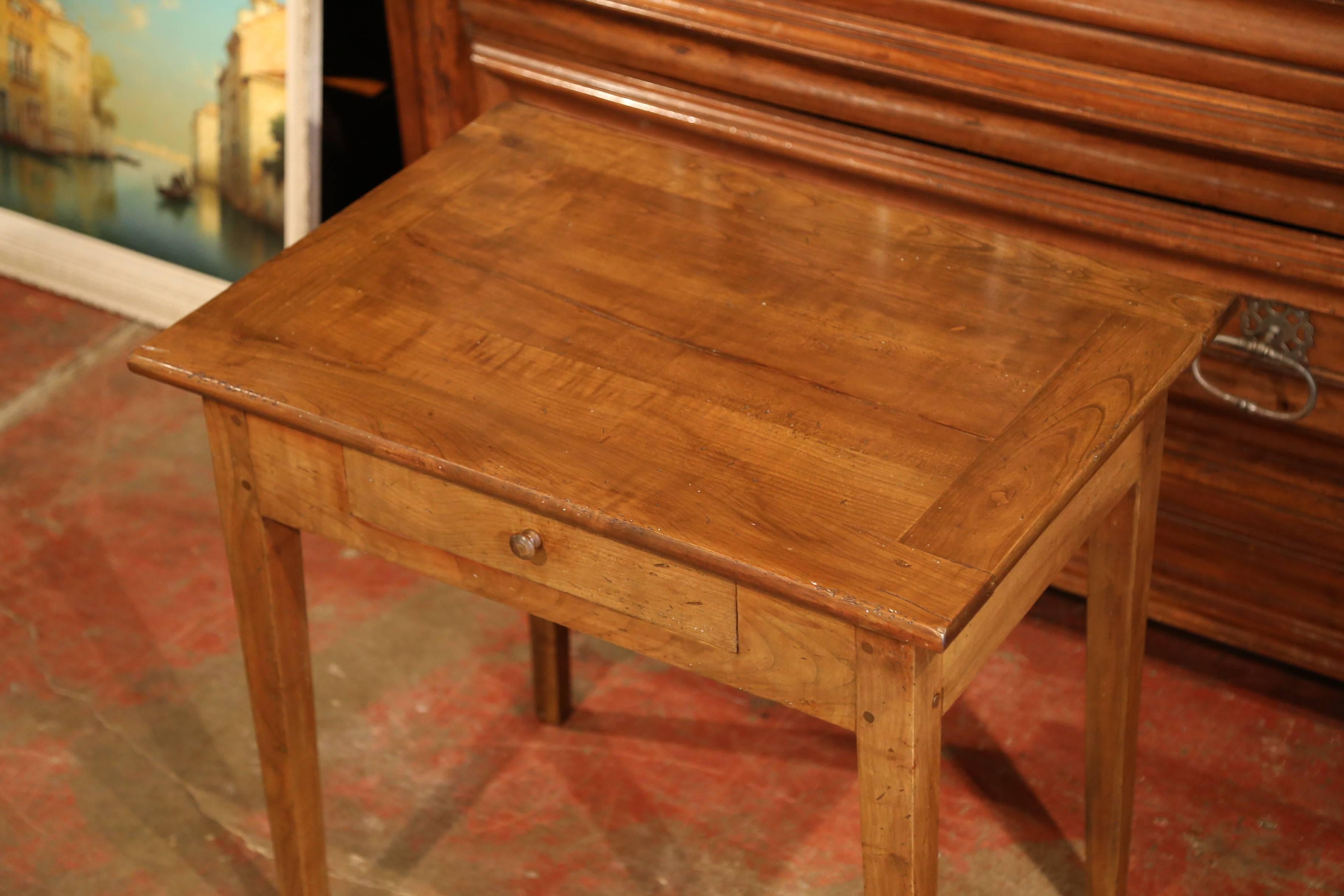 This versatile, antique fruit wood end table was carved in the Poitou region of France, circa 1860. The small desk features a drawer across the front and four slim, tapered legs. This traditional piece is in excellent condition with a rich walnut