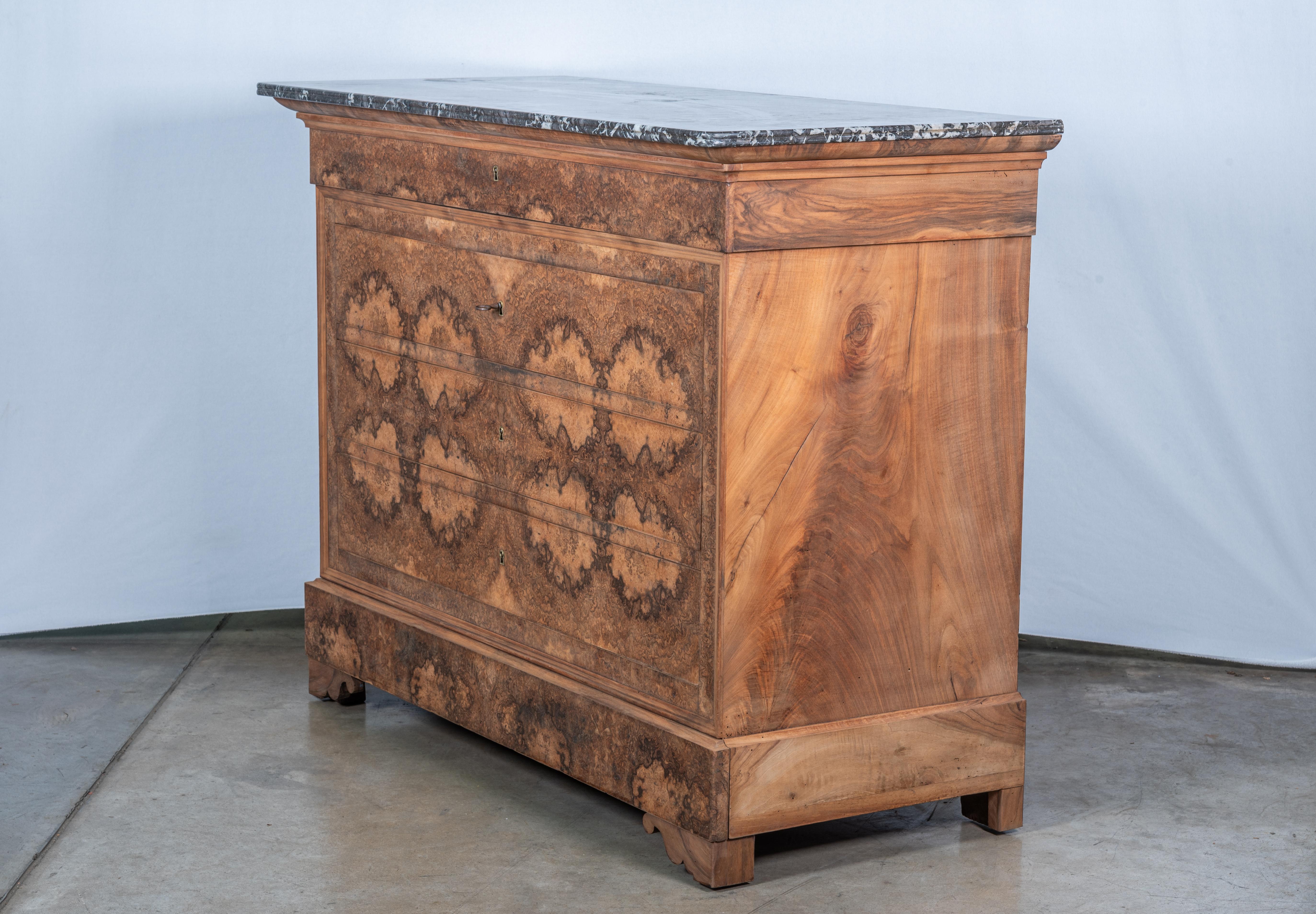 Introduce sophistication into your living space with our exquisite 19th Century French Louis Philippe Commode, showcasing stunning burl veneer and timeless craftsmanship. This magnificent piece embodies the elegance of the Louis Philippe era,