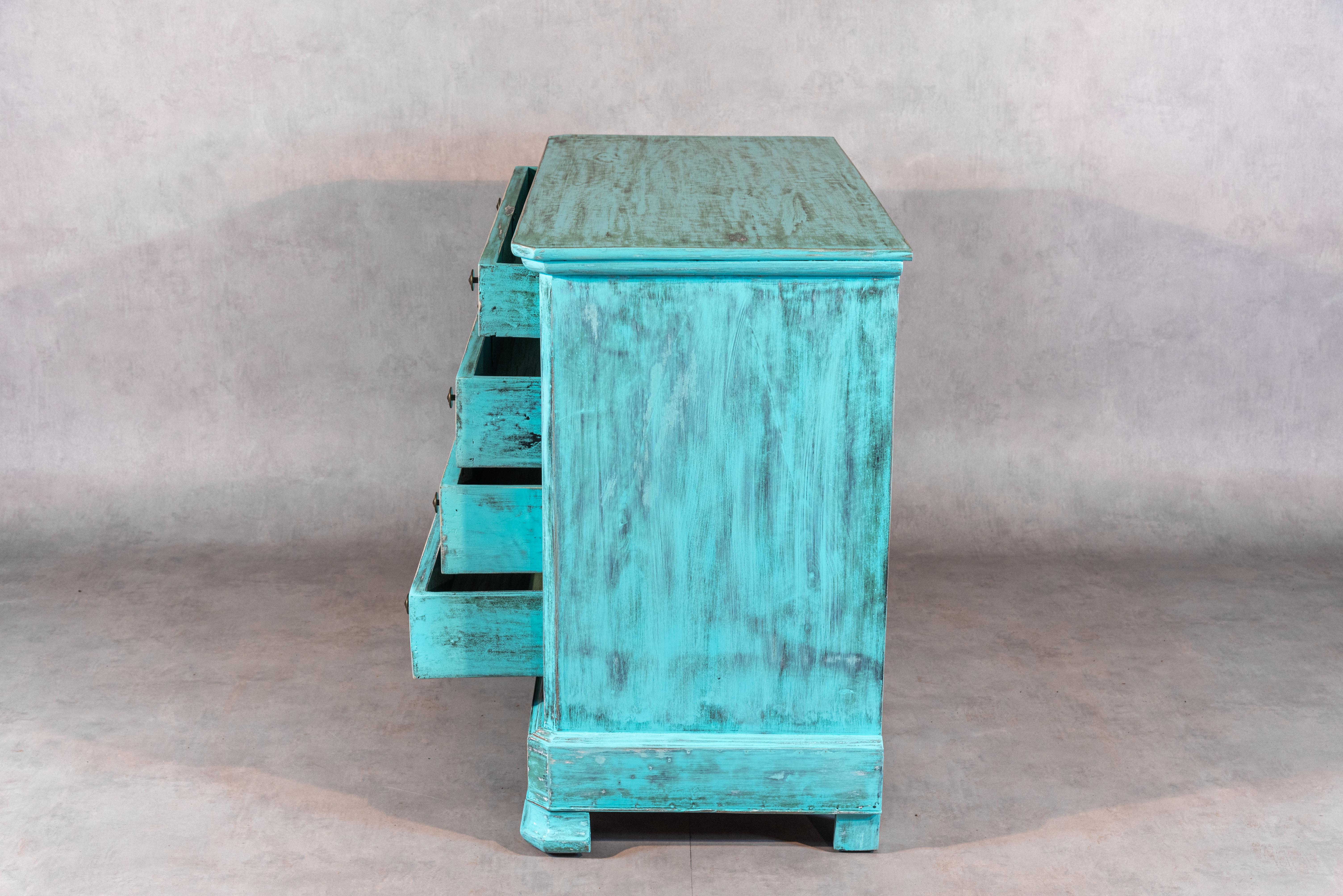 This 19th-century French Louis Philippe commode has been carefully rethought by a professional craftsman and has been sanded, bleached, and painted in a wonderfully unique turquoise patina. It features four ample drawers. This commode will perfectly