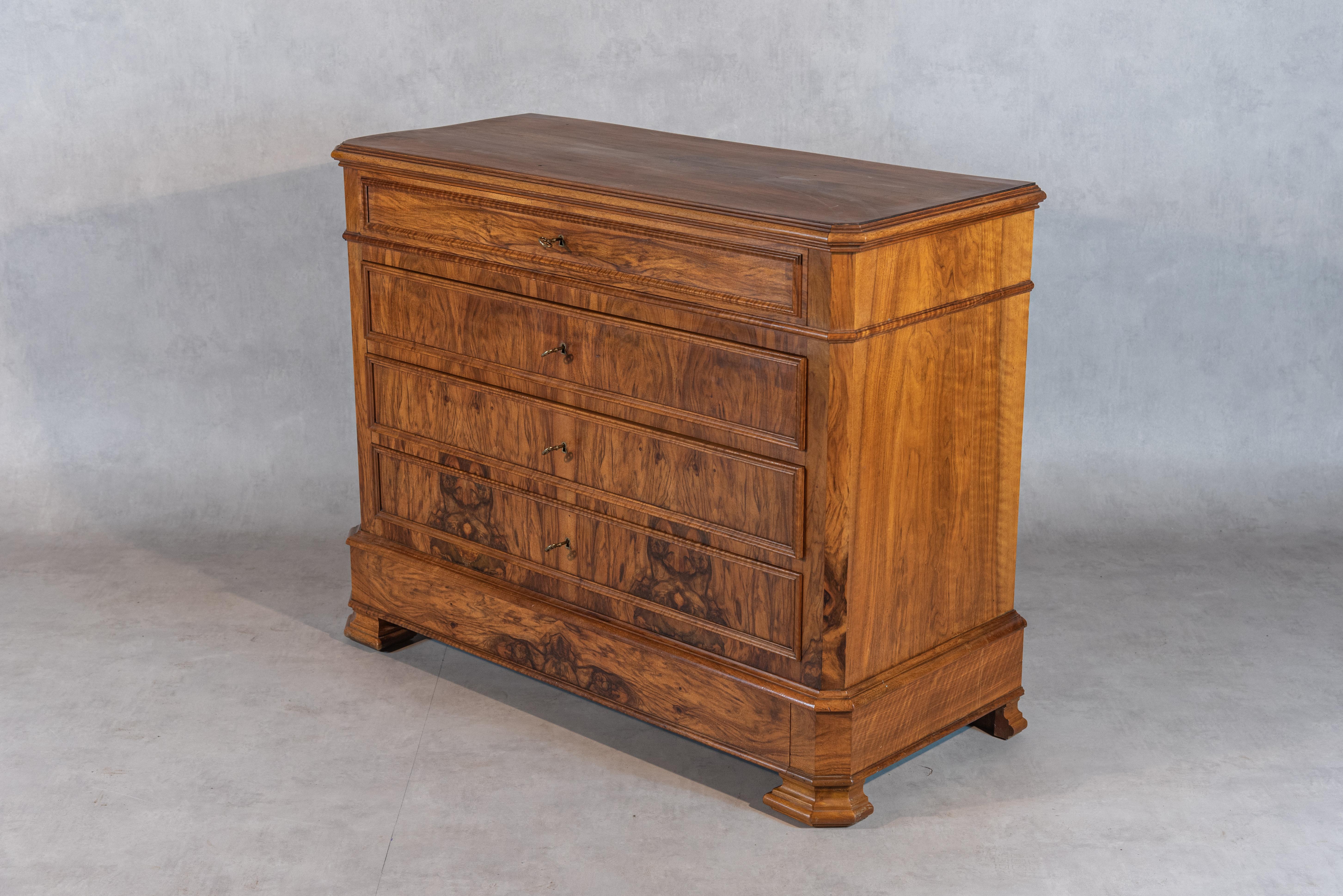 Step into the charm of the 19th century with this exquisite French Louis Philippe Commode. Crafted with meticulous attention to detail, this commode showcases a stunning walnut veneer that accentuates the rich and warm tones of the wood. The smooth