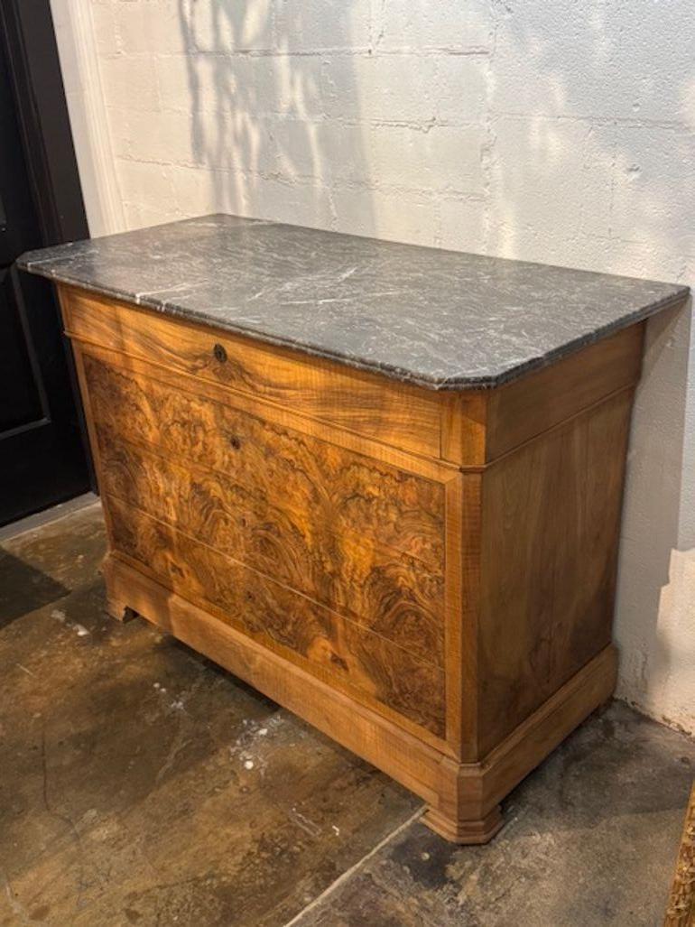 The 19th Century French Louis Philippe Commode with Black Marble Top is a antique piece of furniture that exudes elegance and charm. Featuring a classic style, this commode is perfect for adding a touch of sophistication to their home decor. The