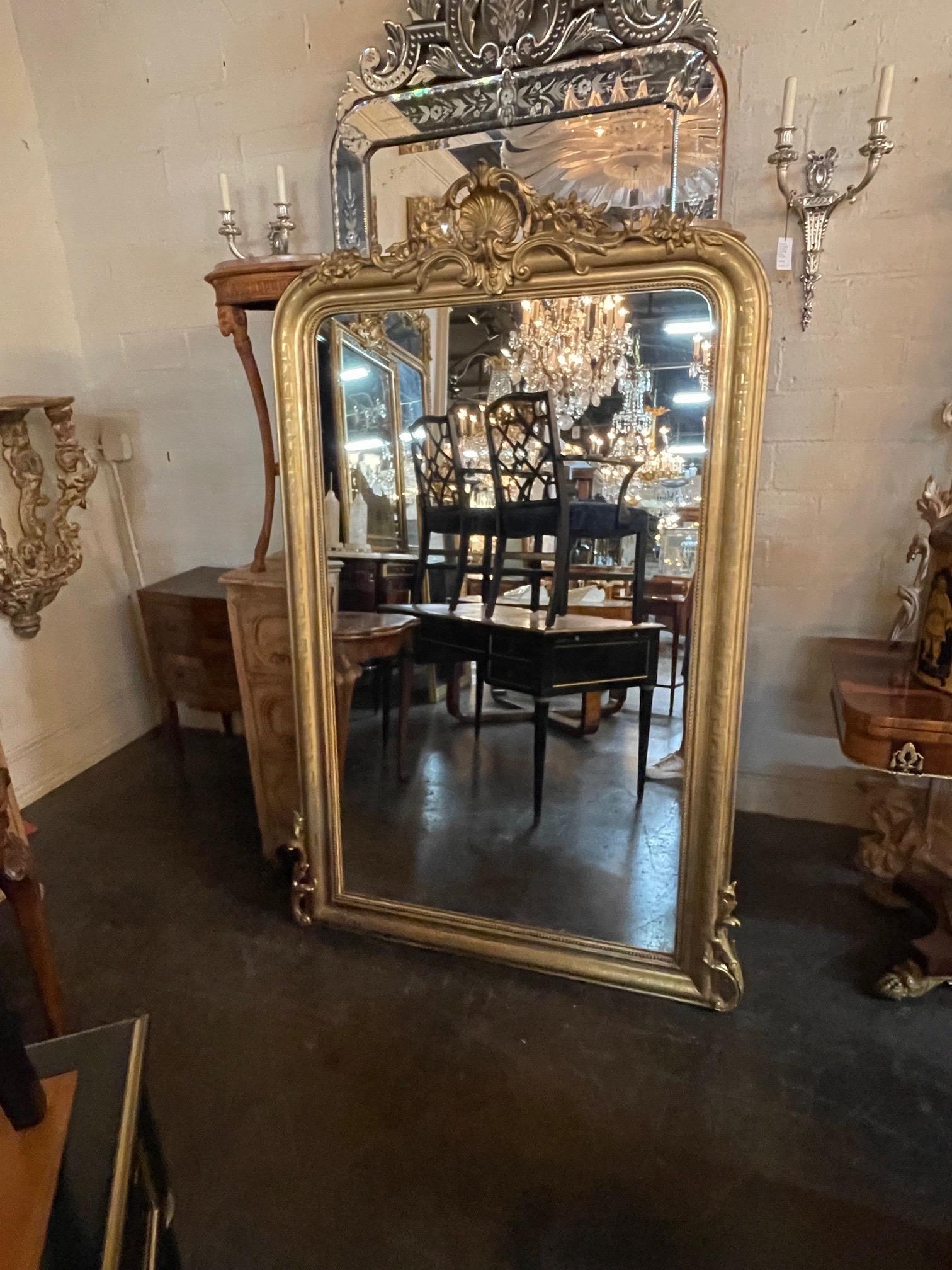 Very fine 19th century French Louis Philippe giltwood mirror with carved crest. This piece also has a pretty pattern on the sides and beaded inner border. Creates a touch of elegance!
