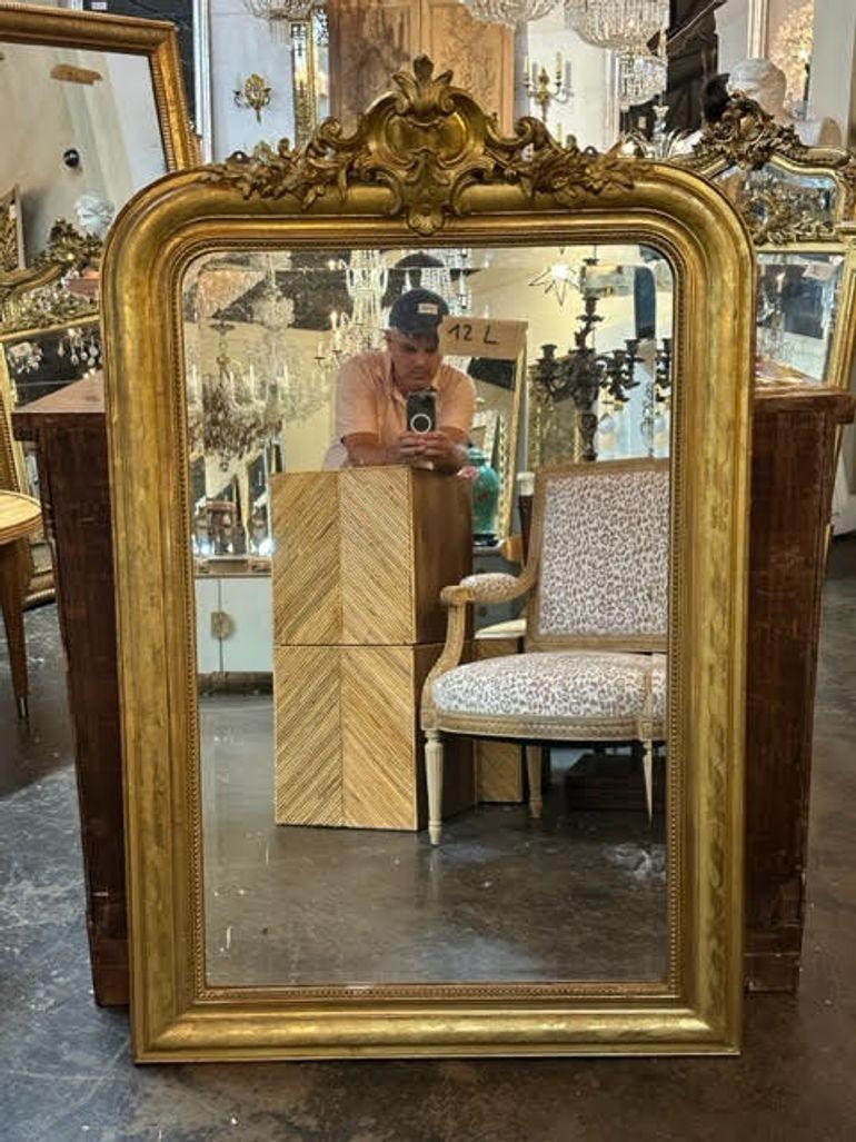 Exquisite 19th century French Louis Philippe giltwood mirror with a crest at the top. Adds a real touch of elegance!!