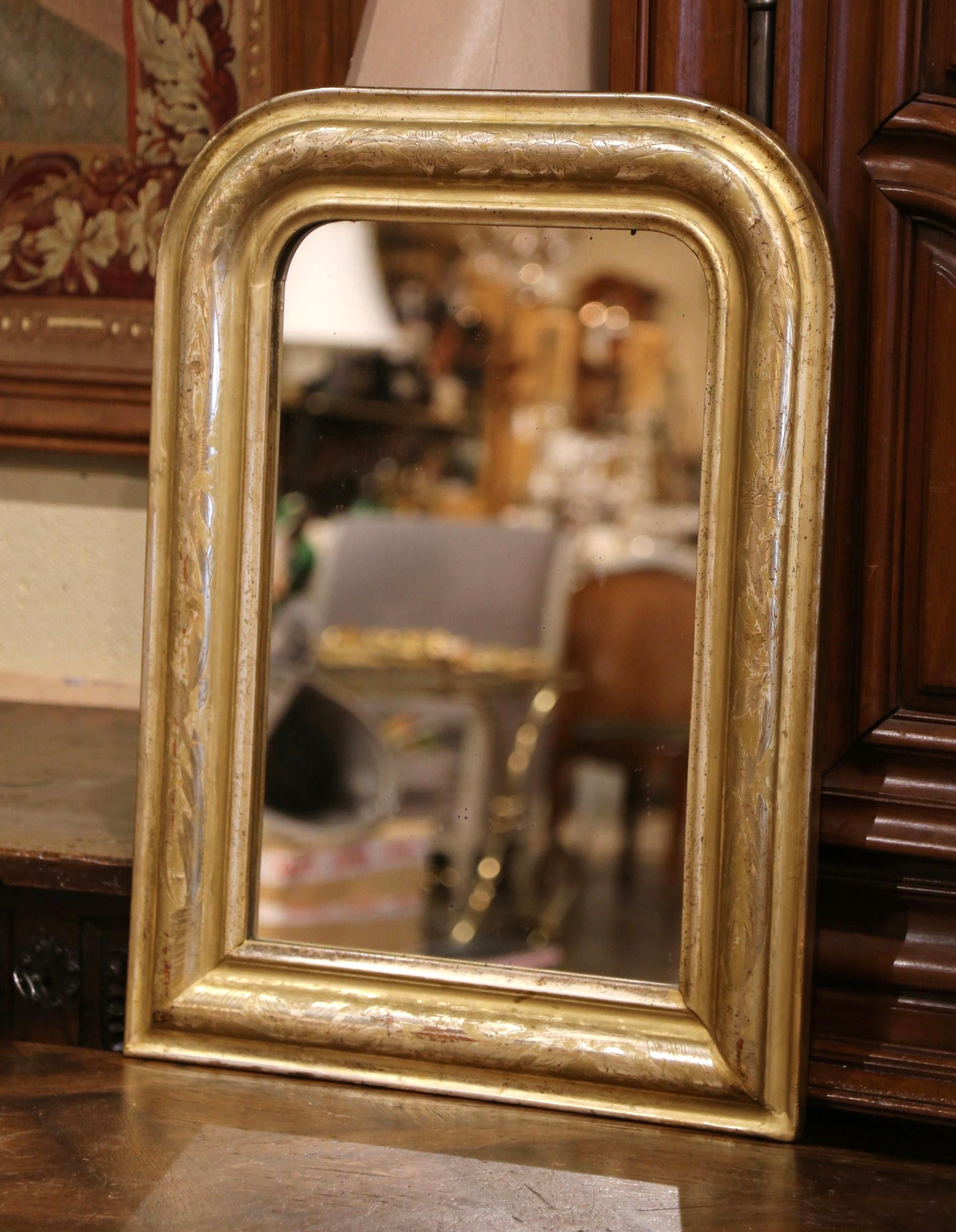 Decorate a powder room or a hallway with this antique gilt wood wall mirror. Crafted in the Burgundy region of France circa 1870, the thick rectangular frame has traditional lines with rounded corners and is embellished with a discrete engraved