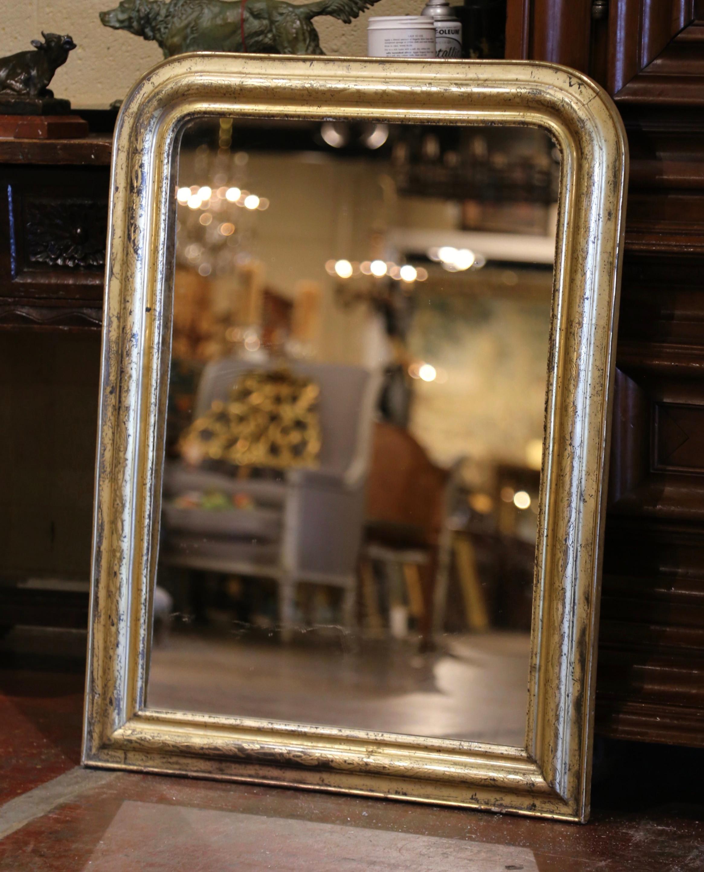 Decorate a powder room or a hallway with this elegant antique gilt wood wall mirror. Crafted in the Burgundy region of France circa 1870, the mirror has traditional lines with rounded corners; the rectangular wall decor is embellished with a