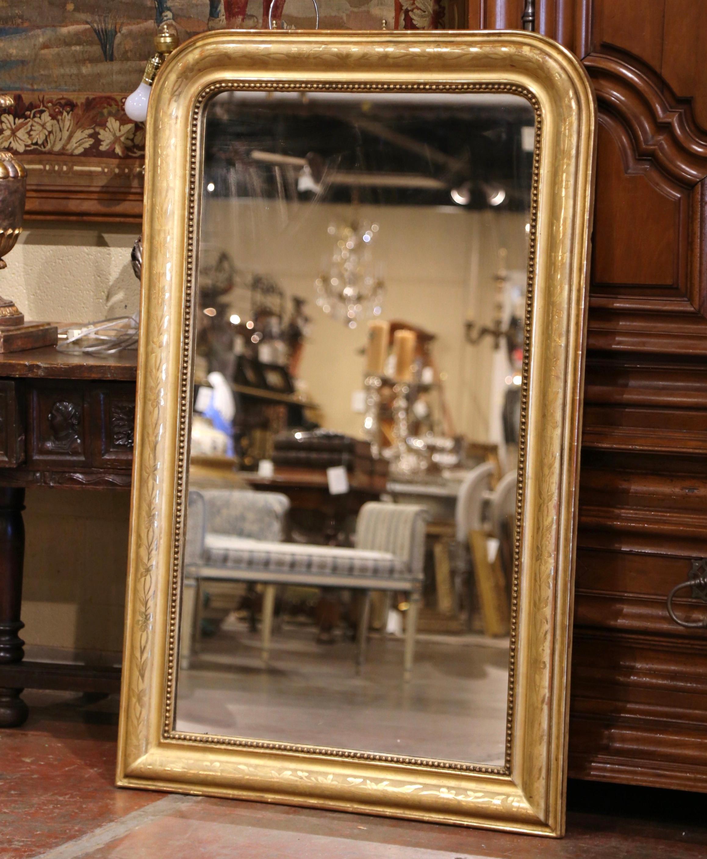 Decorate a bathroom, powder room or entryway with this elegant antique mirror. Crafted in the Burgundy region of France circa 1860, the large gilt mirror has traditional lines with rounded corners; the rectangular thick frame is decorated with a