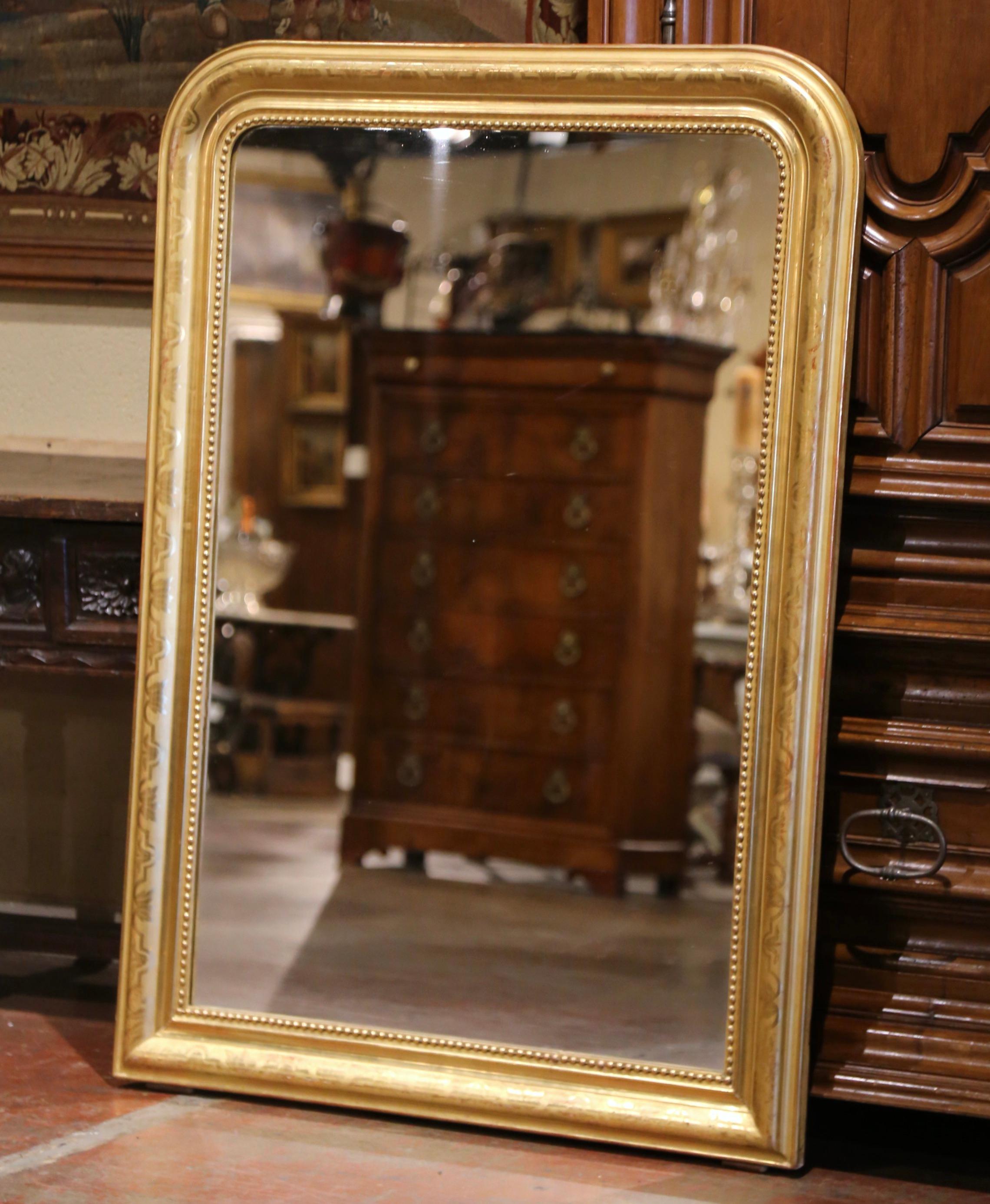 Decorate a bathroom, powder room or entryway with this elegant antique mirror. Crafted in the Burgundy region of France circa 1860, the large gilt mirror has traditional lines with rounded corners; the rectangular thick frame is decorated with a
