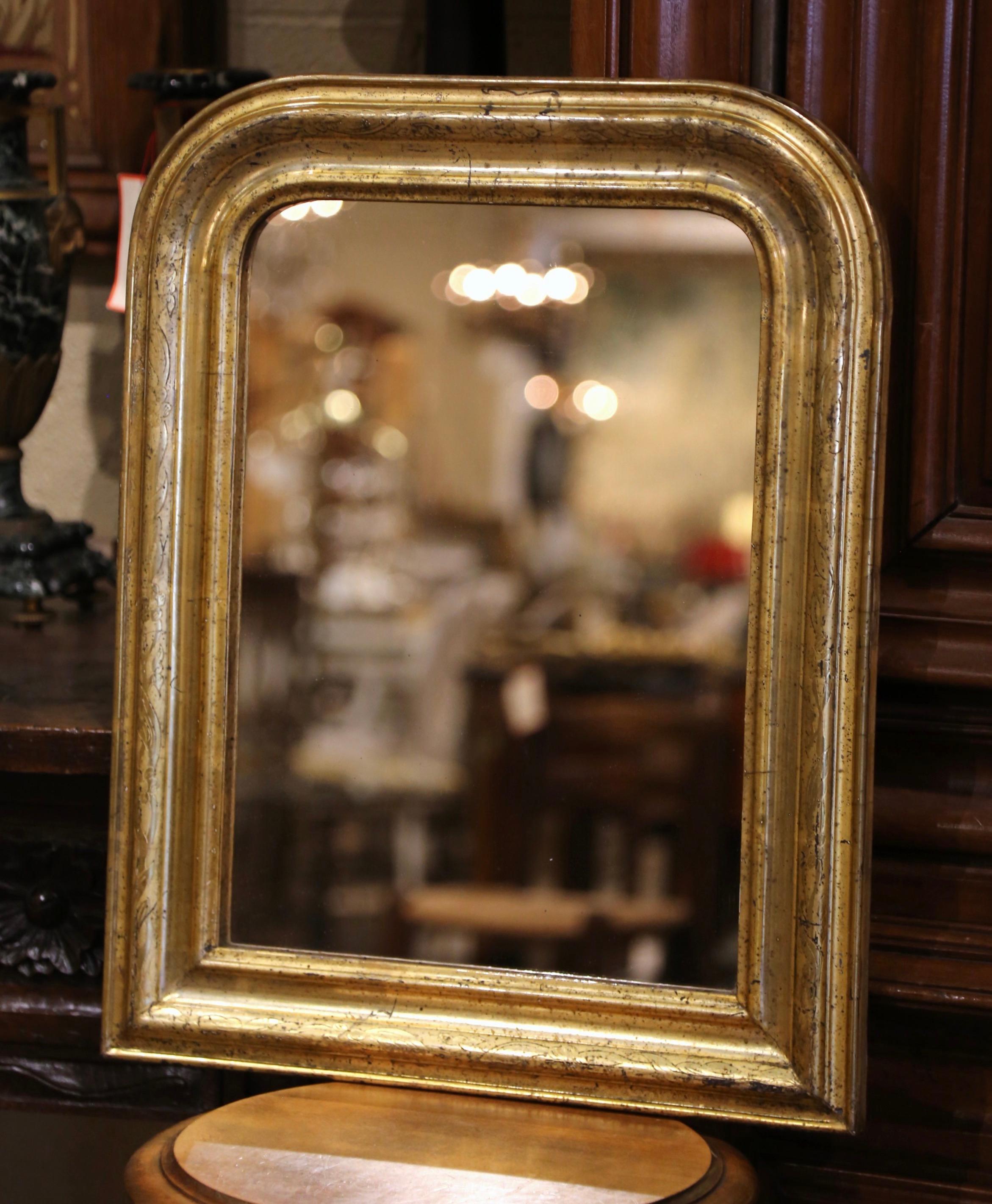 Decorate a powder room or a hallway with this antique gilt wood wall mirror. Crafted in the Burgundy region of France circa 1870, the petite mirror has traditional lines with rounded corners; the rectangular wall decor is embellished with discrete