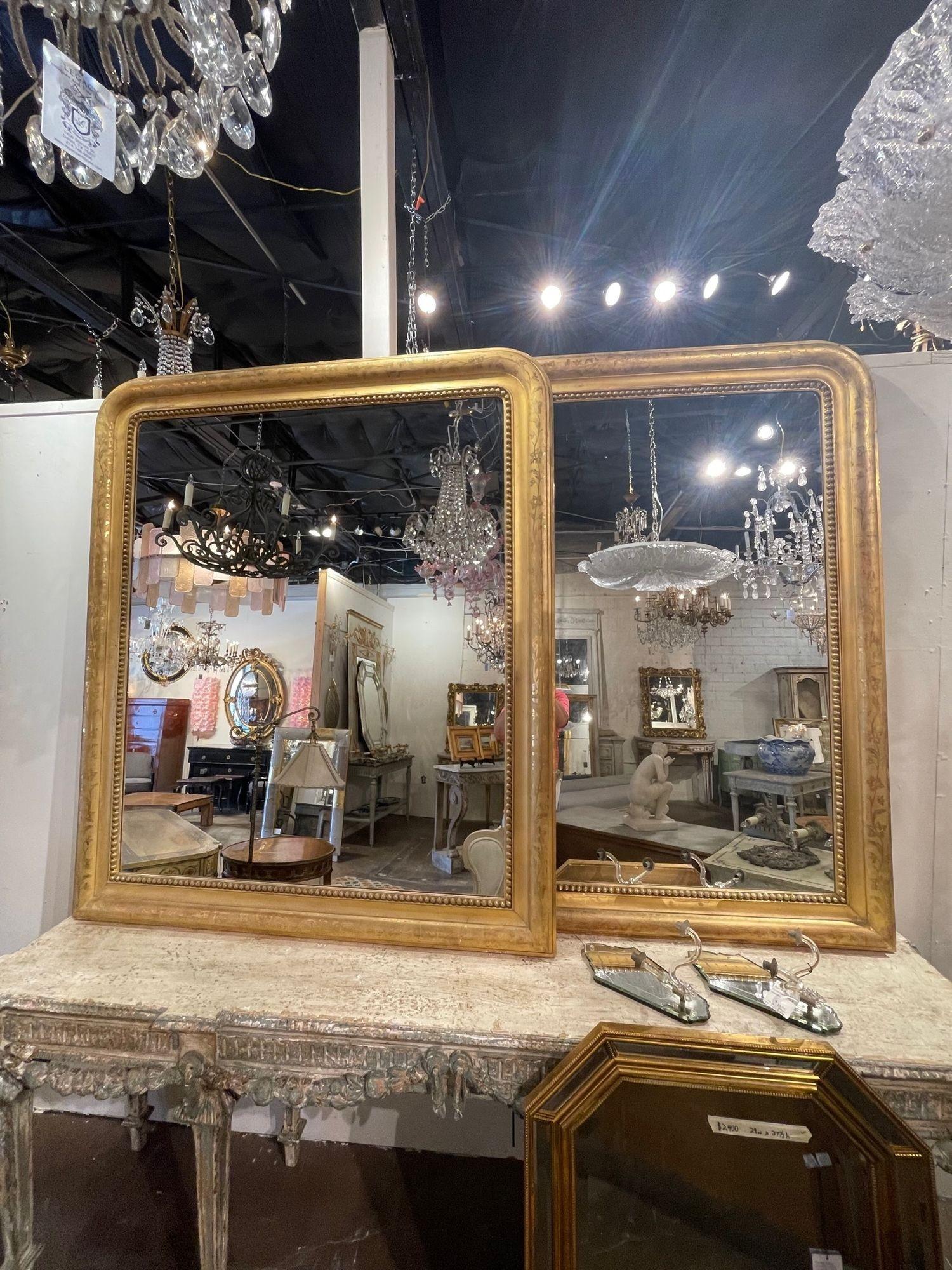 Gorgeous large scale 19th century French Louis Philippe giltwood mirrors with a decorative floral pattern. These also have a pretty inner border. Great for a variety of decors!