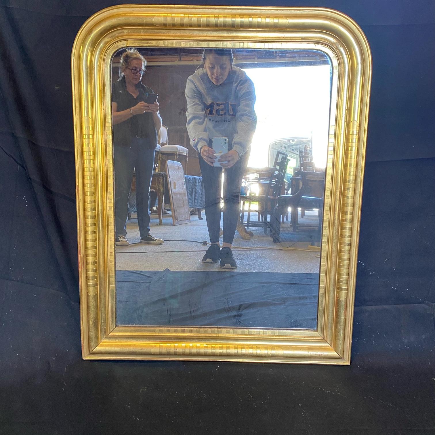 Lovely French decorative Louis Philippe mirror with beautiful gold gilt finish, original slight red undertones and a beautiful bar pattern. 
 #5456