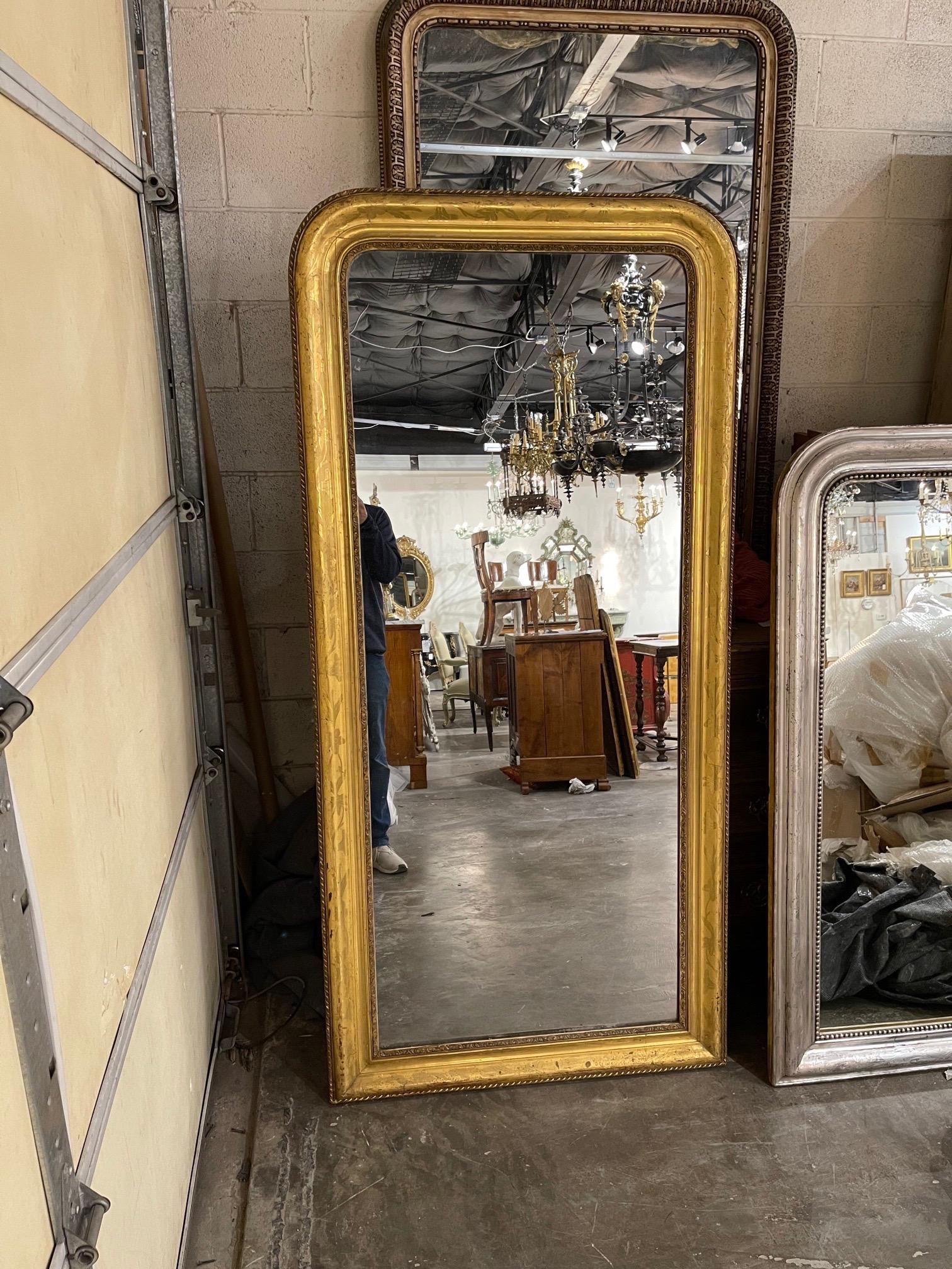 Very fine 19th century French Louis Philippe gold leaf mirror with a pretty floral pattern. Note the tall and narrow size that can be hard to find.