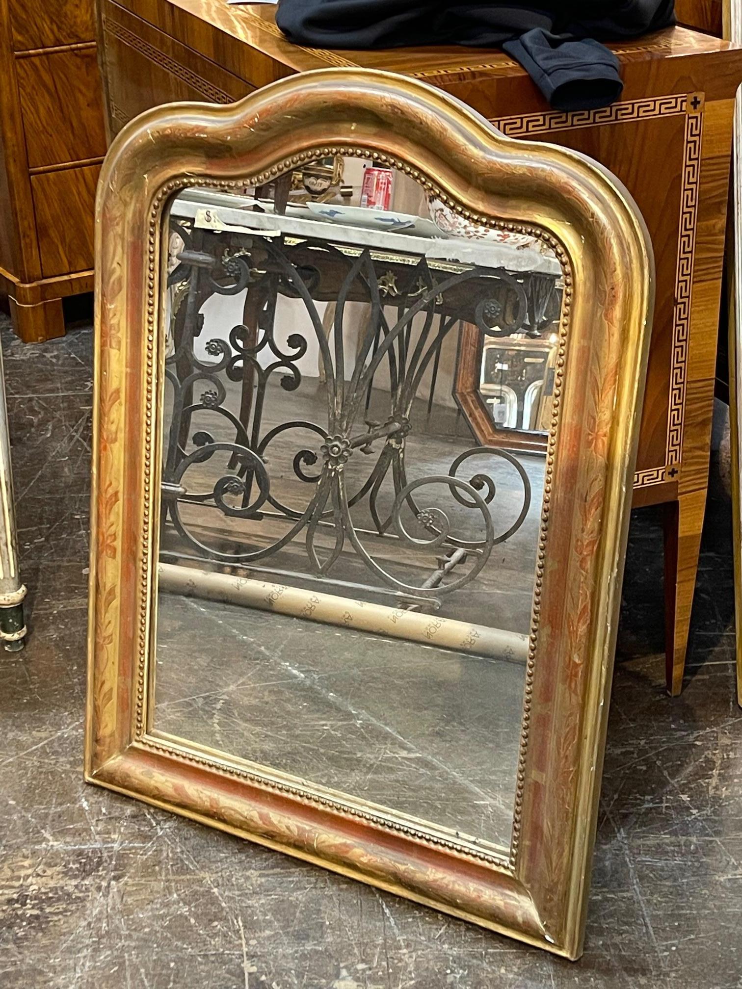 Lovely 19th century French gold leaf Louis Philippe mirror with arched top. This mirror also has a beautiful floral pattern and a beaded inner border. The patina has a touch of red to it. Gorgeous!