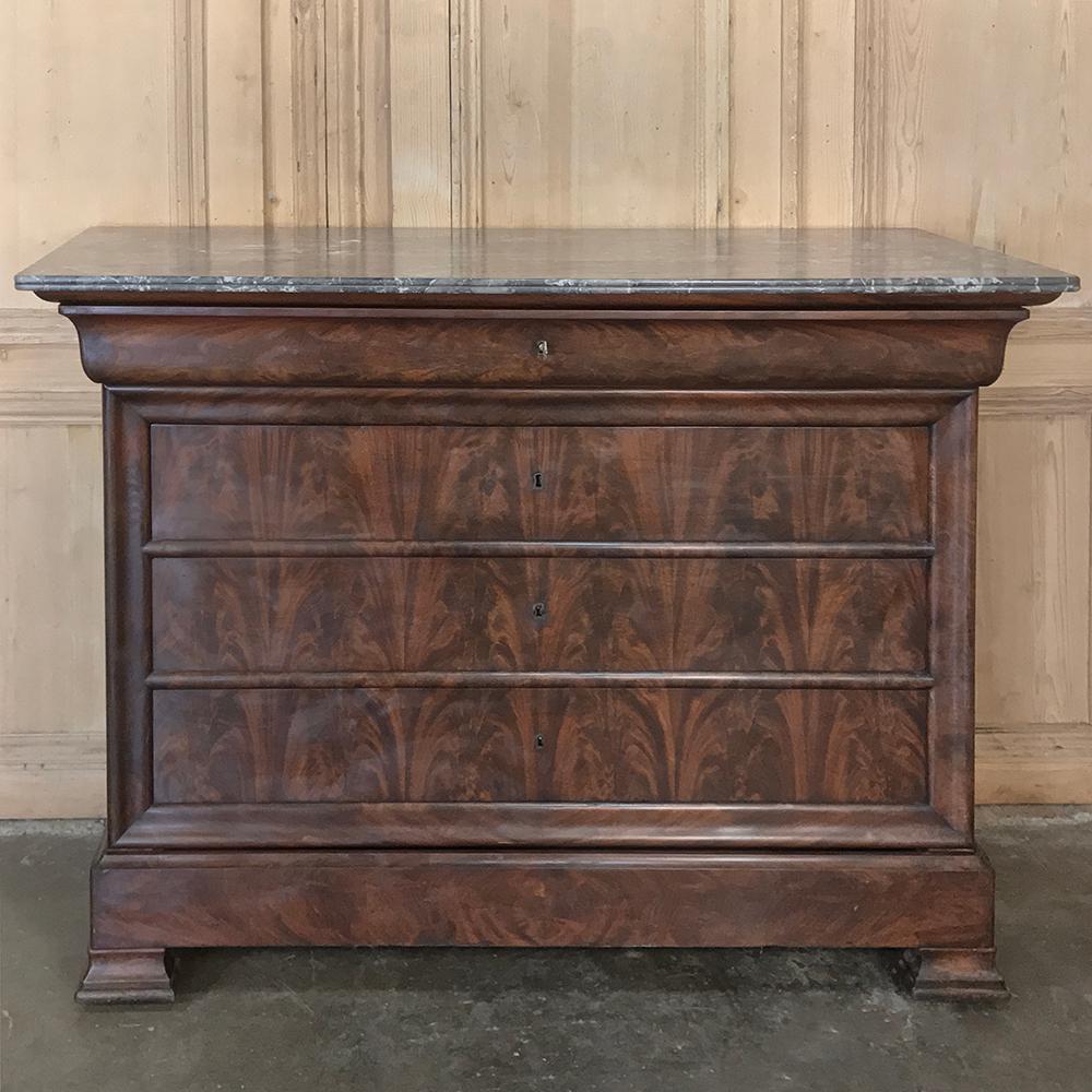 19th century French Louis Philippe marble-top commode was handcrafted from exotic imported mahogany and features the tailored lines and original 