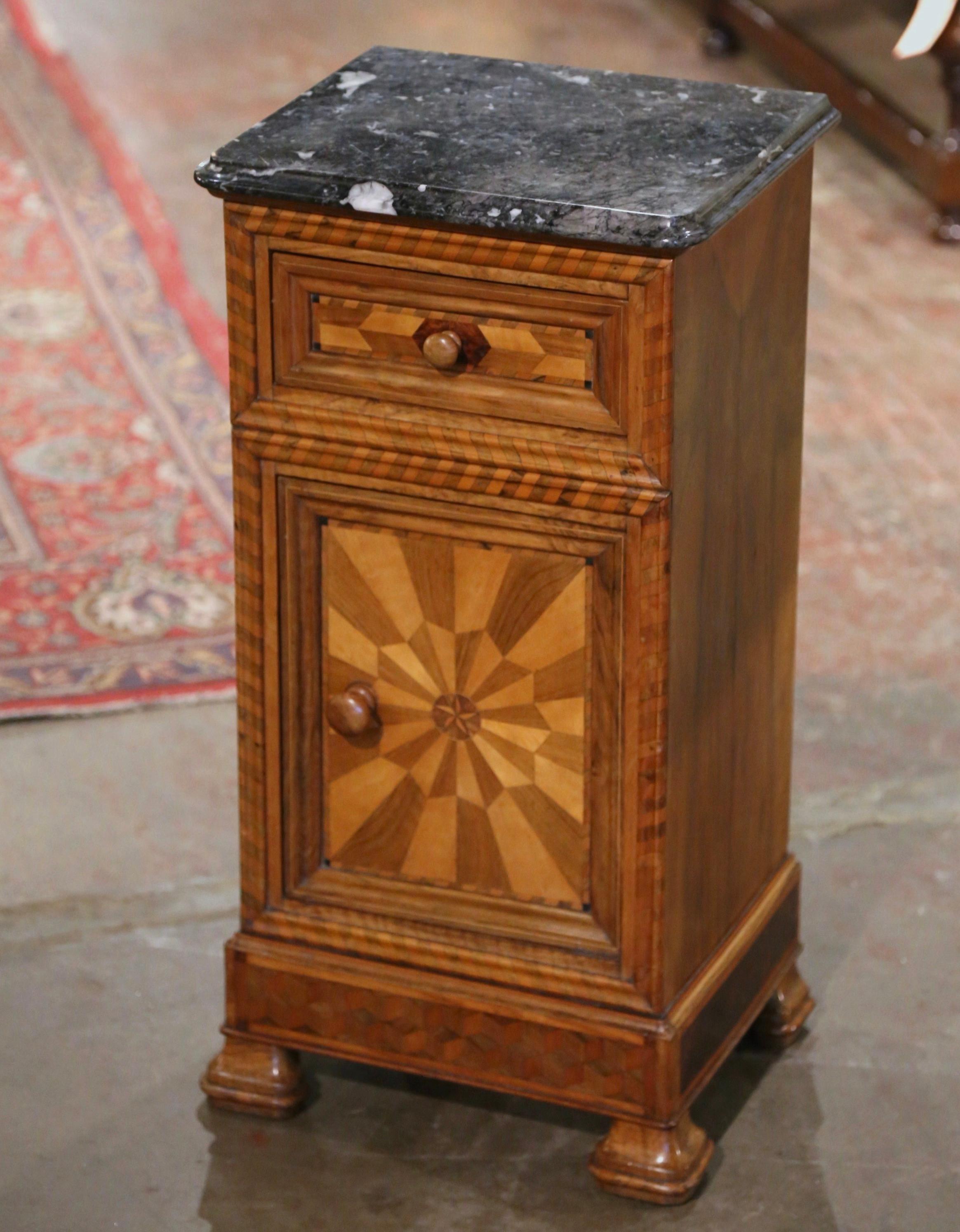 This elegant antique nightstand was crafted in France, circa 1880. The traditional fruit wood cabinet sits on bracket feet over a wide bottom plinth; it is fitted with a single drawer dressed with a wooden knob, over a front door also dressed with a