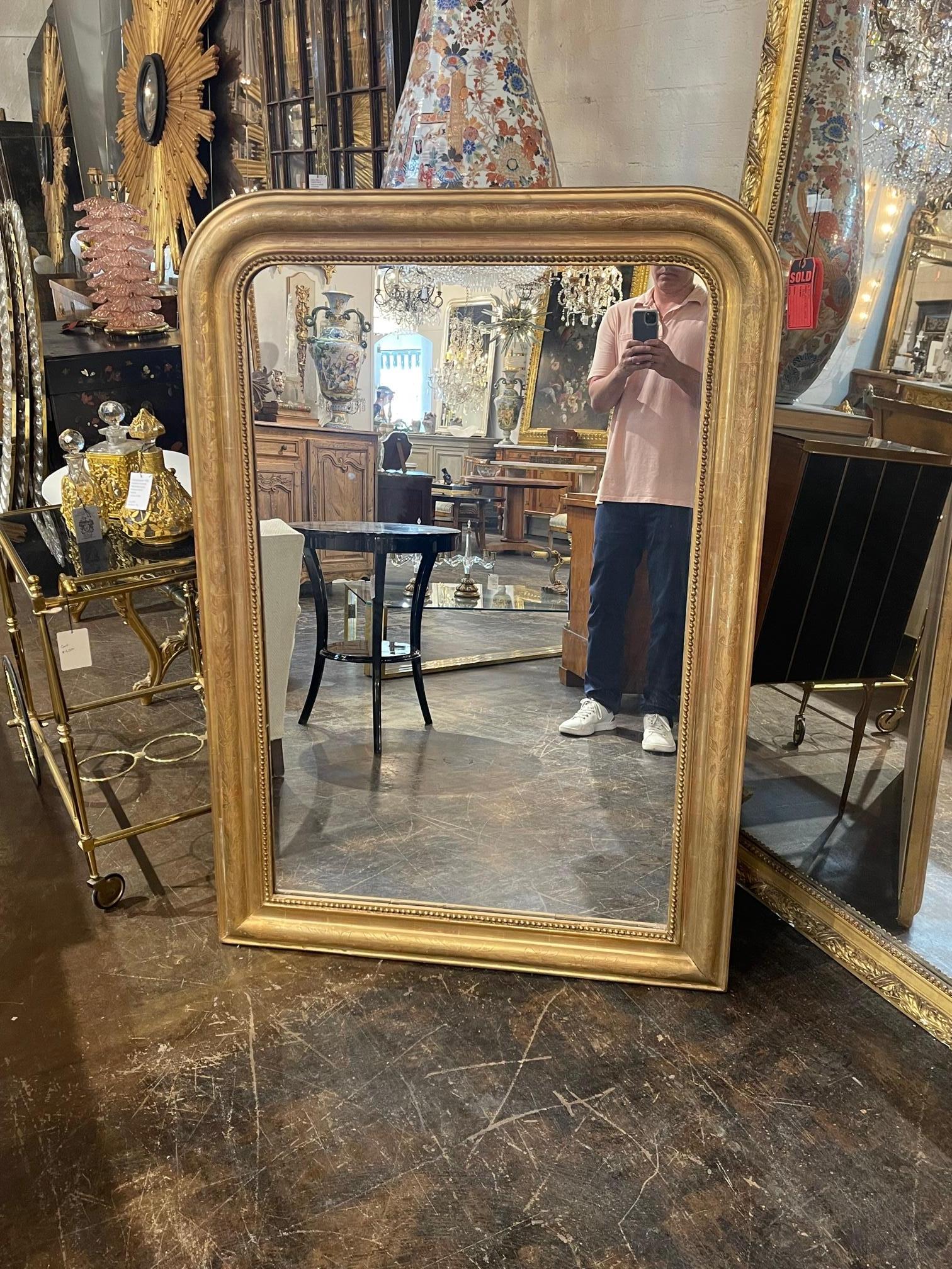 Very nice 19th century gold gilt French Louis Phillipe mirror. The piece has a beaded inner border and a lovely floral pattern. A beautiful classic look!