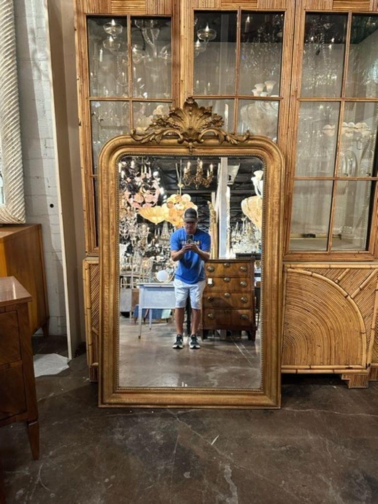 Exceptional 19th century French Louis Philippe mirror with a crest at the top. This mirror also a great patina and a Greek Key pattern. Stunning!!