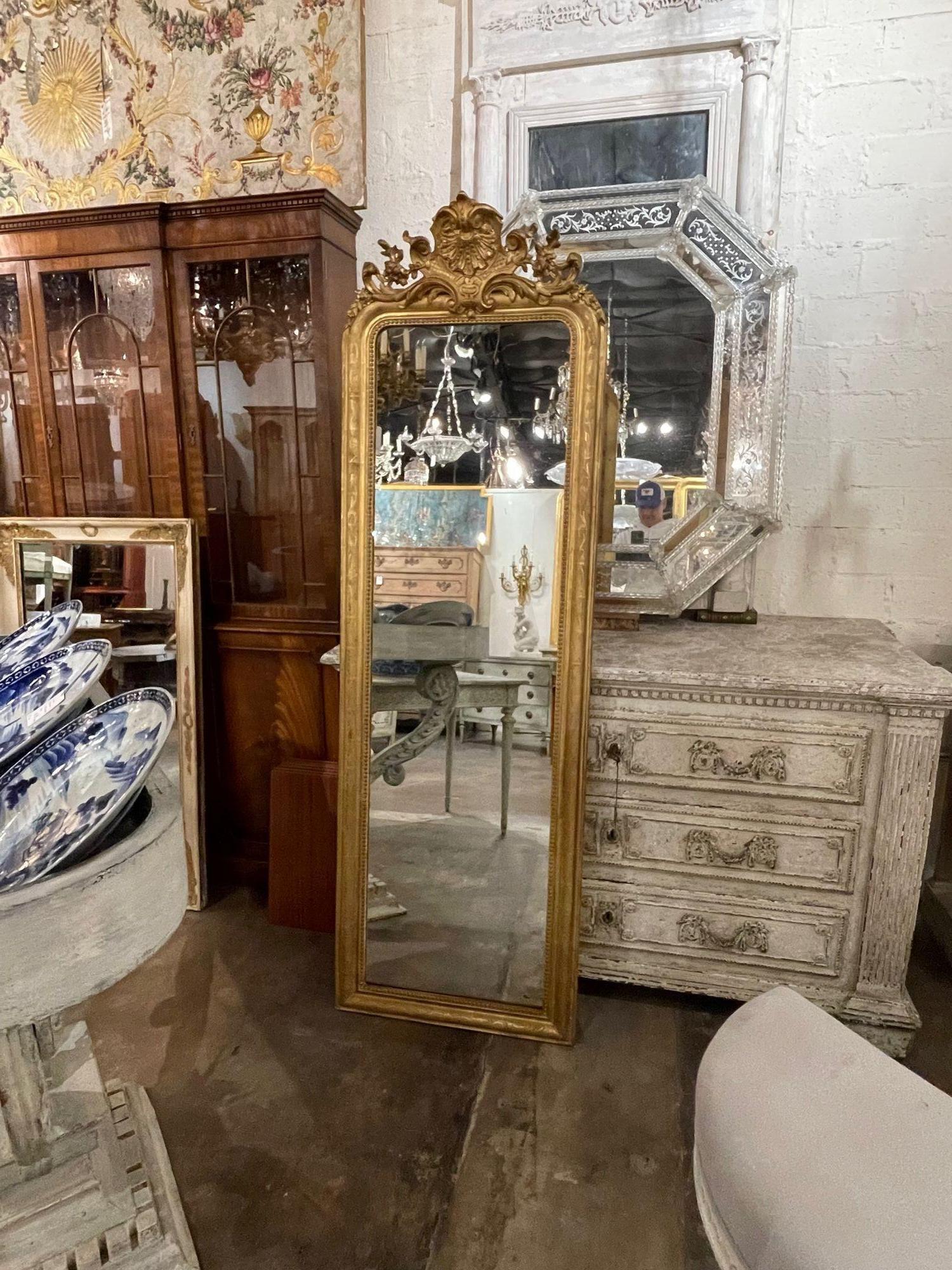 Lovely 19th century French Louis Philippe narrow mirror. A rare size with beautiful a carved crest at the top and a floral pattern. So pretty!!