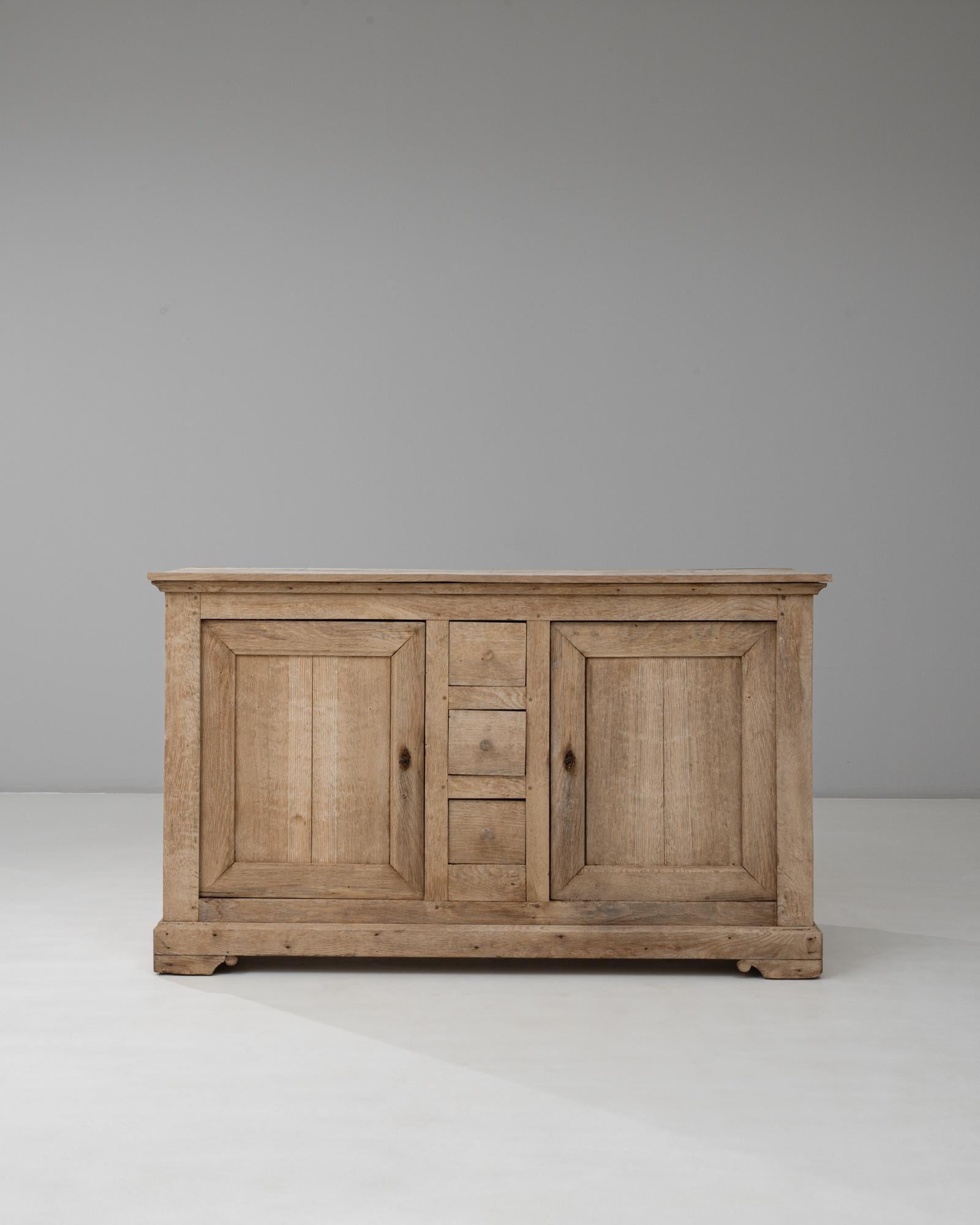 Questo buffet francese in quercia Louis Philippe del XIX secolo esemplifica la sobria eleganza dell'epoca, fondendo simmetria e funzionalità con una maestria senza tempo. Il pezzo presenta un design equilibrato con due ante a pannelli che affiancano