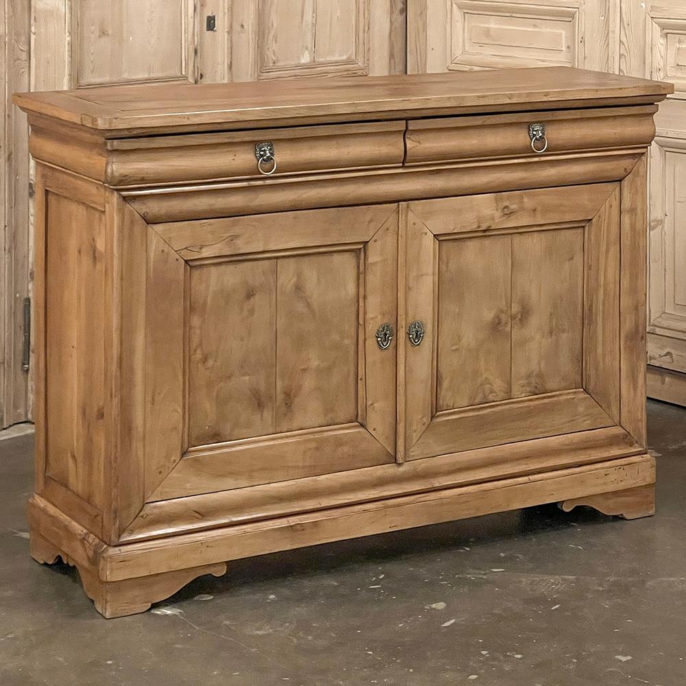 19th Century French Louis Philippe Period Cherry Wood Buffet represents the epitome and subtlety of the genre, rendered in solid old-growth cherry wood left in its original coloration which has achieved a lovely aged hue with patina.  The solid