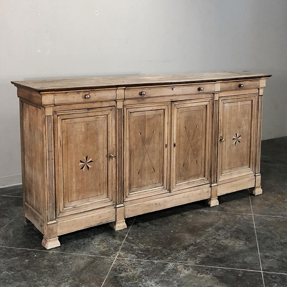 19th century French Louis Philippe period inlaid stripped buffet is an unusual example of the breed, with inlaid arrows and unusual five point Maltese crosses in contrasting light and dark woods to stand out against the backdrop of the stripped