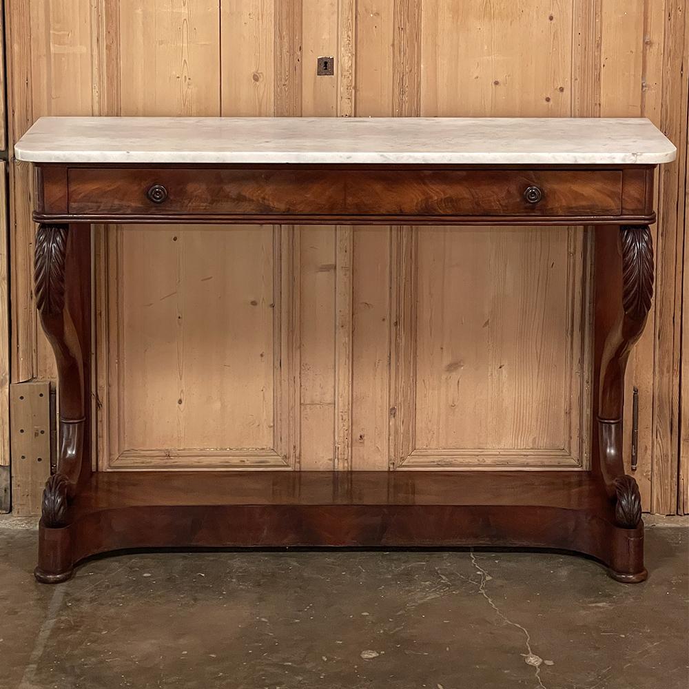 19th Century French Louis Philippe Period mahogany marble top console was hand-crafted by talented artisans, and features the Classic lines inherent in the style. Tailored architecture is enhanced by serpentine-scrolled front legs, carved with